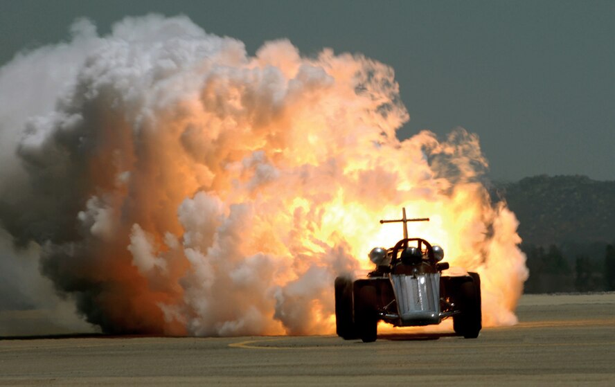 John Collver races his SNJ-5 War Dog against the Smoke-N-Thunder JetCar at the air show May 2. (U.S. Air Force photos by Tech. Sgt. Nic Raven) 
