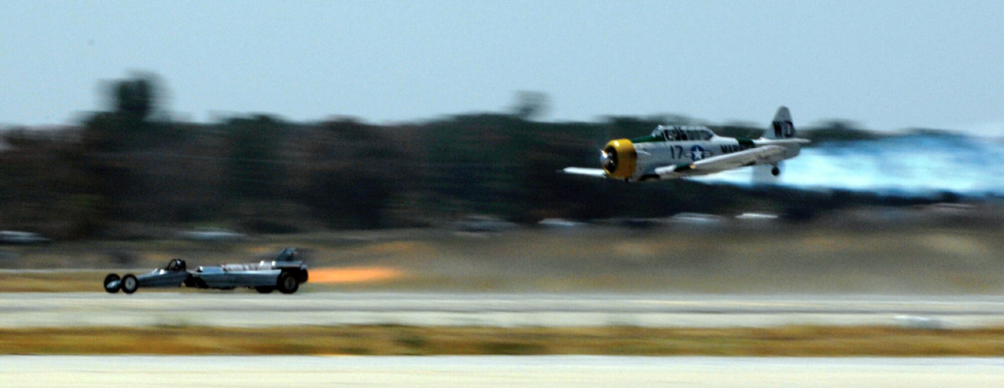 John Collver races his SNJ-5 War Dog against the Smoke-N-Thunder JetCar at the air show May 2. (U.S. Air Force photos by Tech. Sgt. Nic Raven) 
