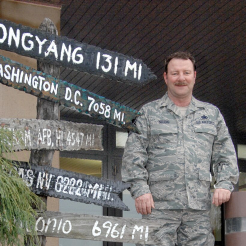 Maj. Gen. Craig Collins retired Chief Master Sgt. Raymond Neubig in a ceremony at March ARB, April 10. Chief Neubig, who served in the Air Force and Air Force Reserve for 33 years, was the only remaining 701st Combat Operations Squadron member who was part of the squadron’s initial 1996 deployment to Korea. Following the initial deployment, Chief Neubig deployed 23 more times for exercises on the Korean Peninsula. (U. S. Air Force photo)

