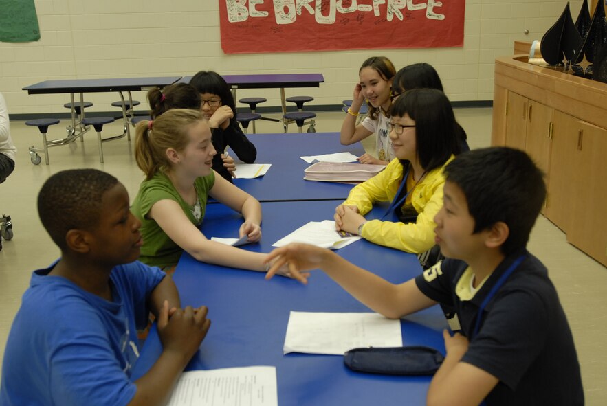 Eighth grade students from Osan Middle School and several local Korean schools converse during the opening day of the 2010 Osan English Camp May 18, 2010, at Osan Air Base, Republic of Korea. Twenty-three students from 22 schools in the Pyeongtaek area are taking part in the program this year, which matches Korean students with host U.S. families for three days of educational and cultural immersion. This is the first year eighth-grade students have been included in the program; since its inception in 2005, the camp was geared toward twelfth-grade students. (U.S. Air Force photo/1st Lt. Chris Hoyler) 
