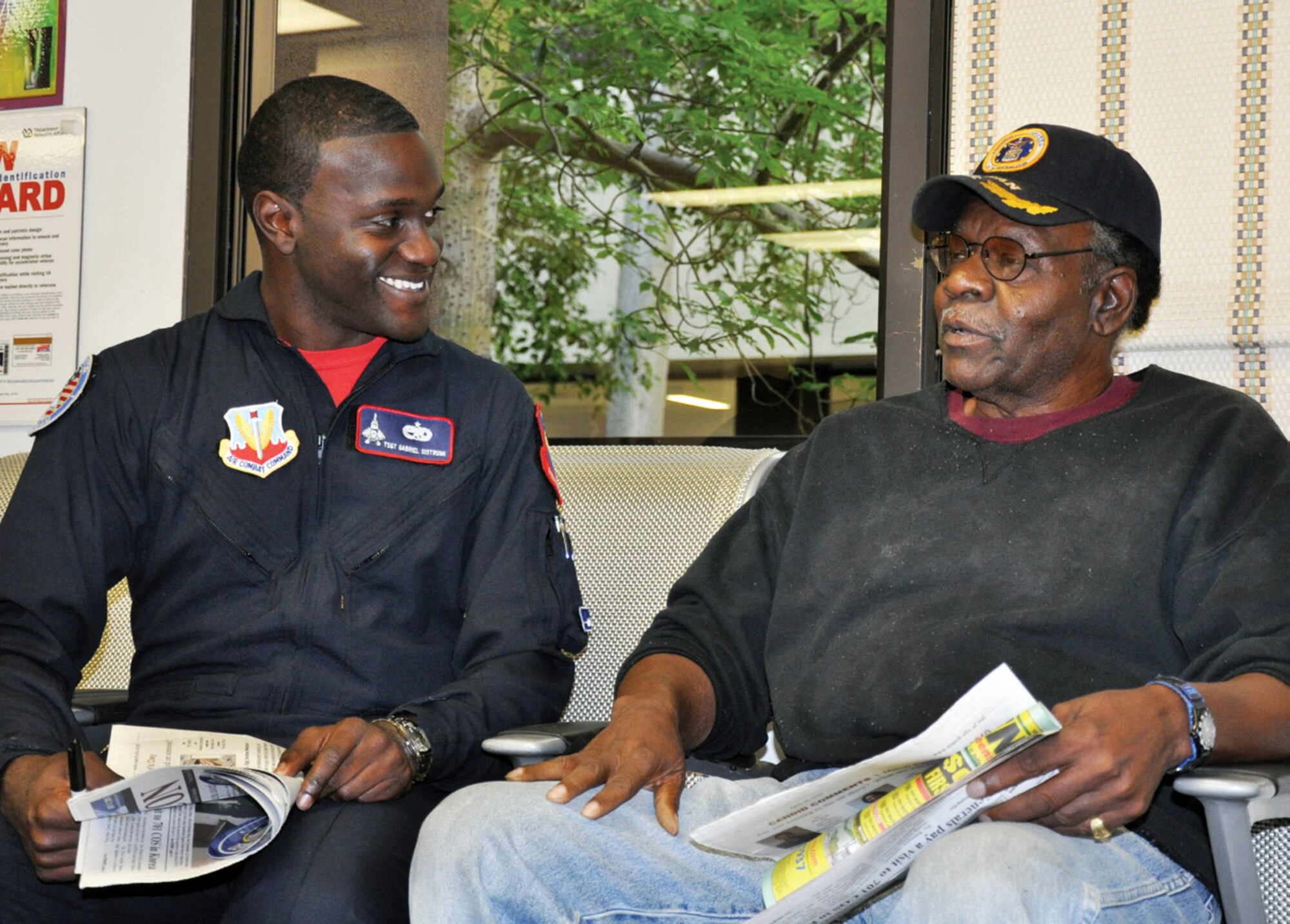 F-22 Raptor Demonstration team member Tech. Sgt. Gabriel Sistrunk laughs as he listens to a veteran telling a humorous story in a lobby at the Loma Linda Veteran’s Hospital April 30. (U.S. Air Force photo by Capt Ashley Norris)
