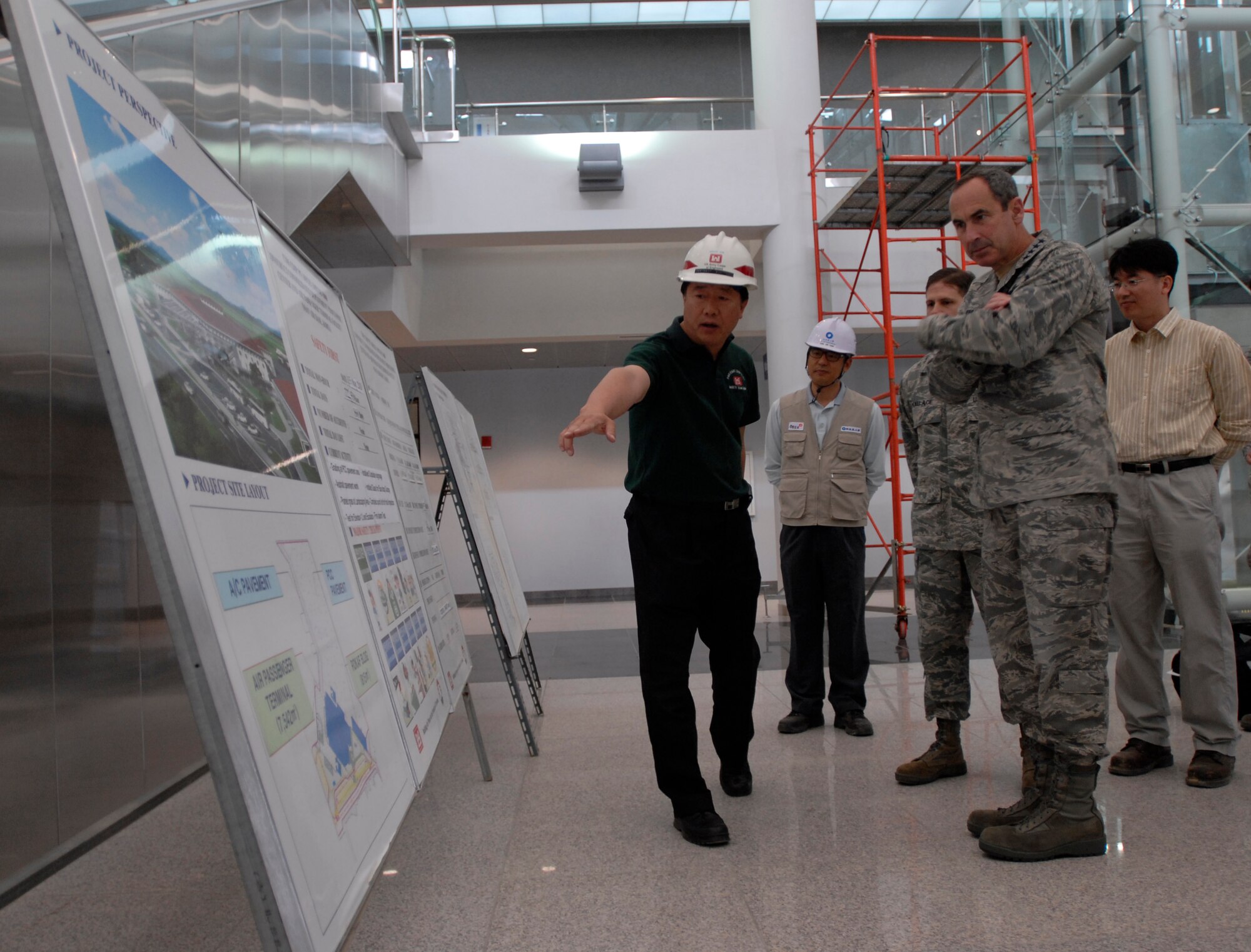 Gen. Raymond Johns, Air Mobility Command commander, receives an update on the construction status of the Osan Air Base Joint Reception Center from Mr. Bruce Kim, US Army Corps of Engineers, May 16 at Osan AB, Republic of Korea. The Osan JRC is scheduled for completion in late 2010 and will serve as the entry and departure points for all space-available travelers at Osan. (U.S. Air Force photo by 1st Lt. Chris Hoyler)
