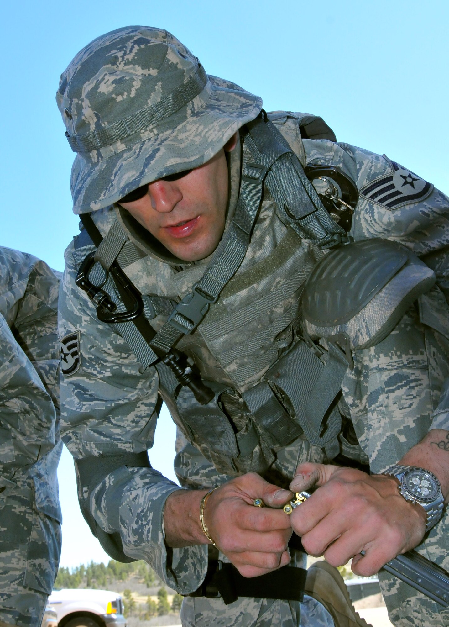 Staff Sgt. Alex Andriyanov from the Space and Missile Systems Center's 61st Security Forces Squadron loads an M4 magazine prior to the marksmanship competition at Guardian Challenge 2010 May 17. (Photo by Lou Hernandez)