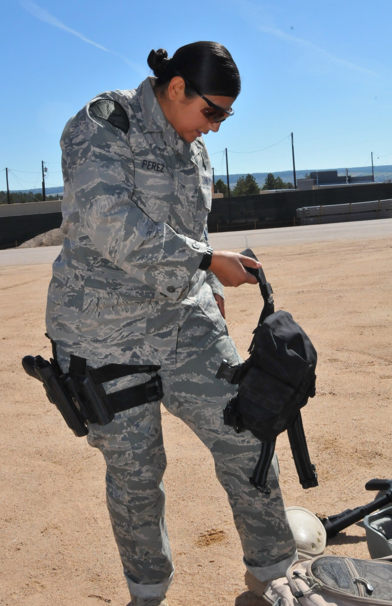 Officer Yvette Perez from the Space and Missile Systems Center's 61st Security Forces Squadron prepares to put on her gear for the marksmanship competition at Guardian Challenge 2010 May 17. (Photo by Lou Hernandez)