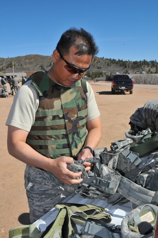 Tech. Sgt. Rochanapan Silpe from the Space and Missile Systems Center's 61st Security Forces Squadron prepares his gear before the marksmanship competition for Guardian Challenge 2010 May 17. (Photo by Lou Hernandez)