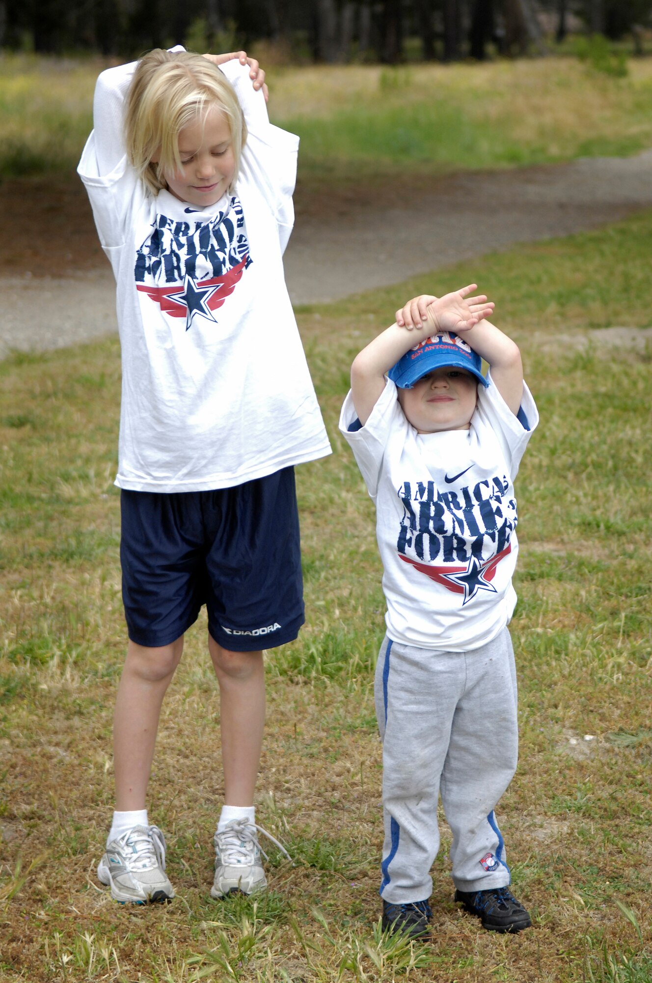 VANDENBERG AIR FORCE BASE, Calif. -- Annika and Jonah Sederberg, children of Tech. Sgt. Micky Sederberg, from the 533rd Training Squadron, warm up before beginning the Armed Forces Kids Run here Saturday, May 15, 2010. Children of Vandenberg AFB competed in the Armed Forces Kids Run at the base trail by the fitness center.  (U.S. Air Force photo/Airman 1st Class Andrew Lee)