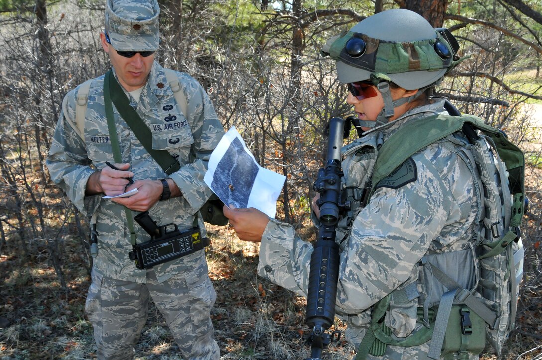 DoD Officer Yvette Perez from the 61st Security Forces Squadron, Space and Missile Systems Center, relays intelligence information extracted from one of the simulated insurgents to Maj. Doug Welter, Headquarters Air Force Space Command A7S Security Forces observer controller, during the tactics competition at Guardian Challenge 2010 May 16 (Photo by Lou Hernandez)