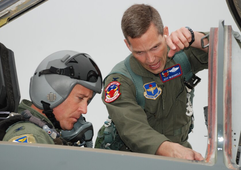 LAUGHLIN AIR FORCE BASE, Texas – Col. Jeffrey McDaniels, 47th Flying Training Wing commander, discusses some last minute flight details with Col. Andrew Cernicky, 47th Mission Support Group commander, just before Colonel McDaniels’ last flight as wing commander May 17. Upon landing, as is tradition for the outgoing commander, Colonel McDaniels taxied through an arch of water supplied by fire trucks from Laughlin’s fire department and was drenched with a fire hose by his wife after exiting the aircraft. (U.S. Air Force photo by Airman 1st Class Blake Mize)