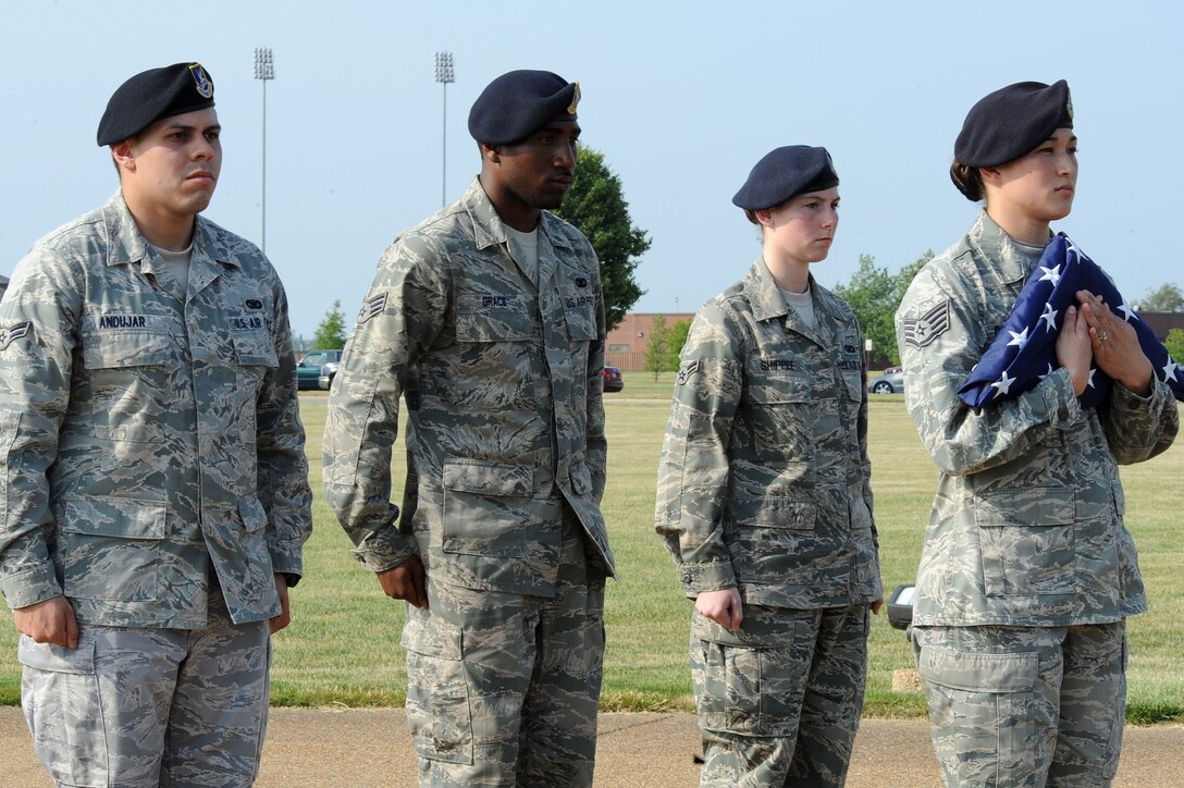 LANGLEY AIR FORCE BASE, Va. -- Staff Sgt. Evie Dougherty, Airman 1st Class Jonathon Andujar, Senior Airman Antonio Grace, and Airman 1st Class Ashley Shippee, 633d Security Forces Squadron patrolmen, present the flag during a formal retreat ceremony honoring National Police Week May 14. Police Week is held annually to honor police officers, military and civilian, who have lost their lives in the line of duty. (U.S. Air Force Photo/Staff Sgt. Christina M. Styer) 
