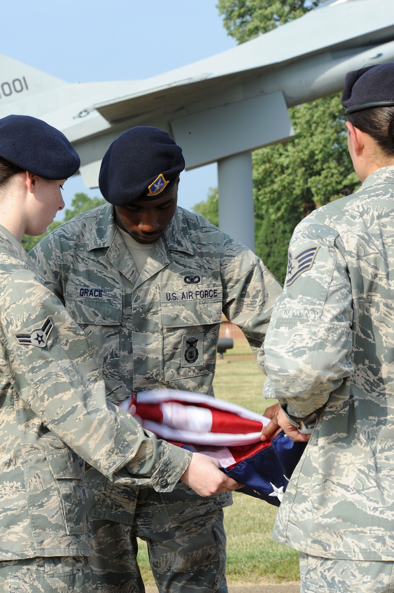 LANGLEY AIR FORCE BASE, Va. -- Staff Sgt. Evie Dougherty, Airman 1st Class Jonathon Andujar, Senior Airman Antonio Grace, and Airman 1st Class Ashley Shippee, 633d Security Forces Squadron patrolmen, fold the flag during a formal retreat ceremony honoring National Police Week May 14. Police Week is held annually to honor police officers, military and civilian, who have lost their lives in the line of duty. (U.S. Air Force Photo/Staff Sgt. Christina M. Styer) 