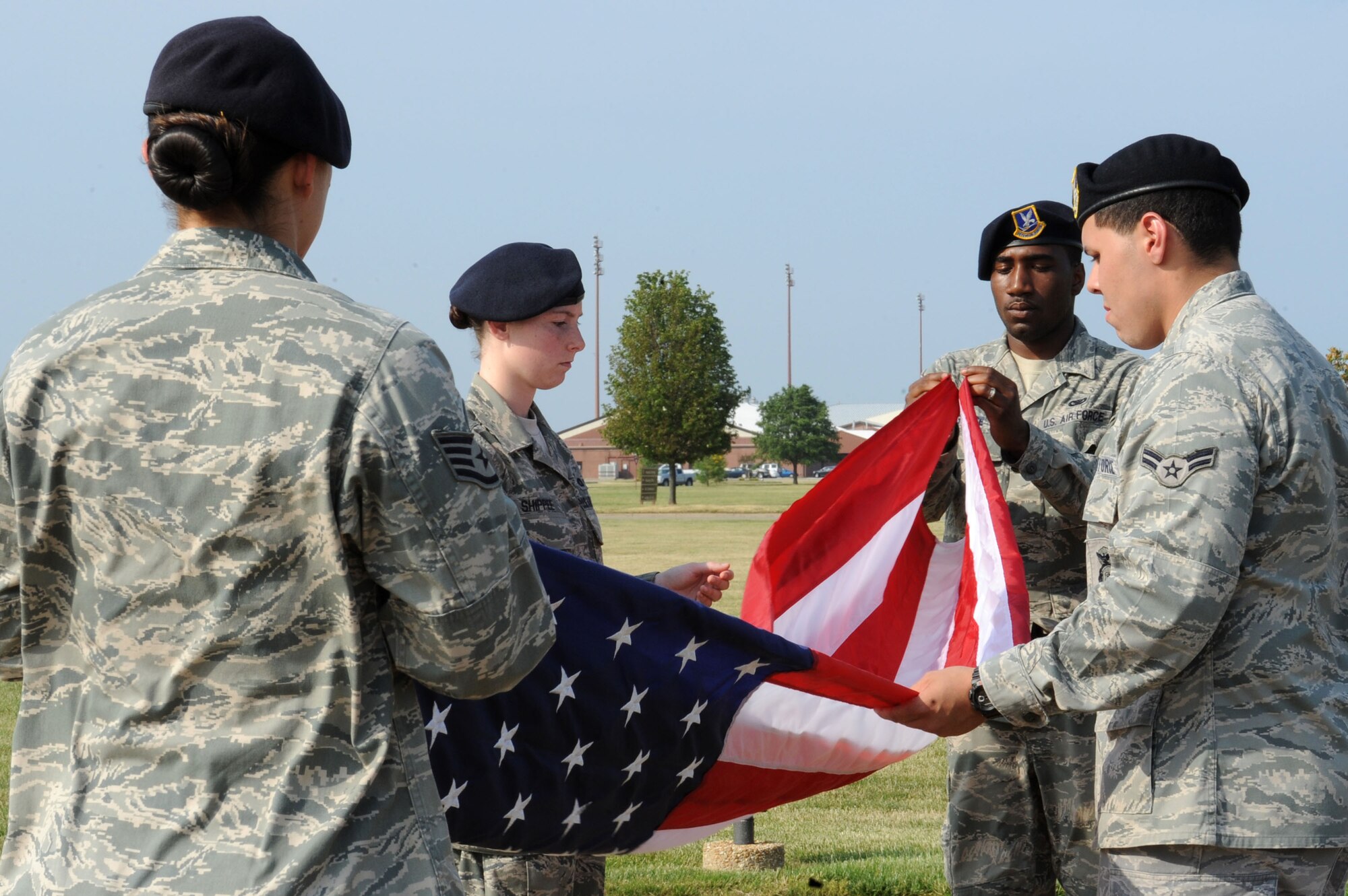 LANGLEY AIR FORCE BASE, Va. -- Staff Sgt. Evie Dougherty, Airman 1st Class Jonathon Andujar, Senior Airman Antonio Grace, and Airman 1st Class Ashley Shippee, 633d Security Forces Squadron patrolmen, fold the flag during a formal retreat ceremony honoring National Police Week May 14. Police Week is held annually to honor police officers, military and civilian, who have lost their lives in the line of duty. (U.S. Air Force Photo/Staff Sgt. Christina M. Styer) 