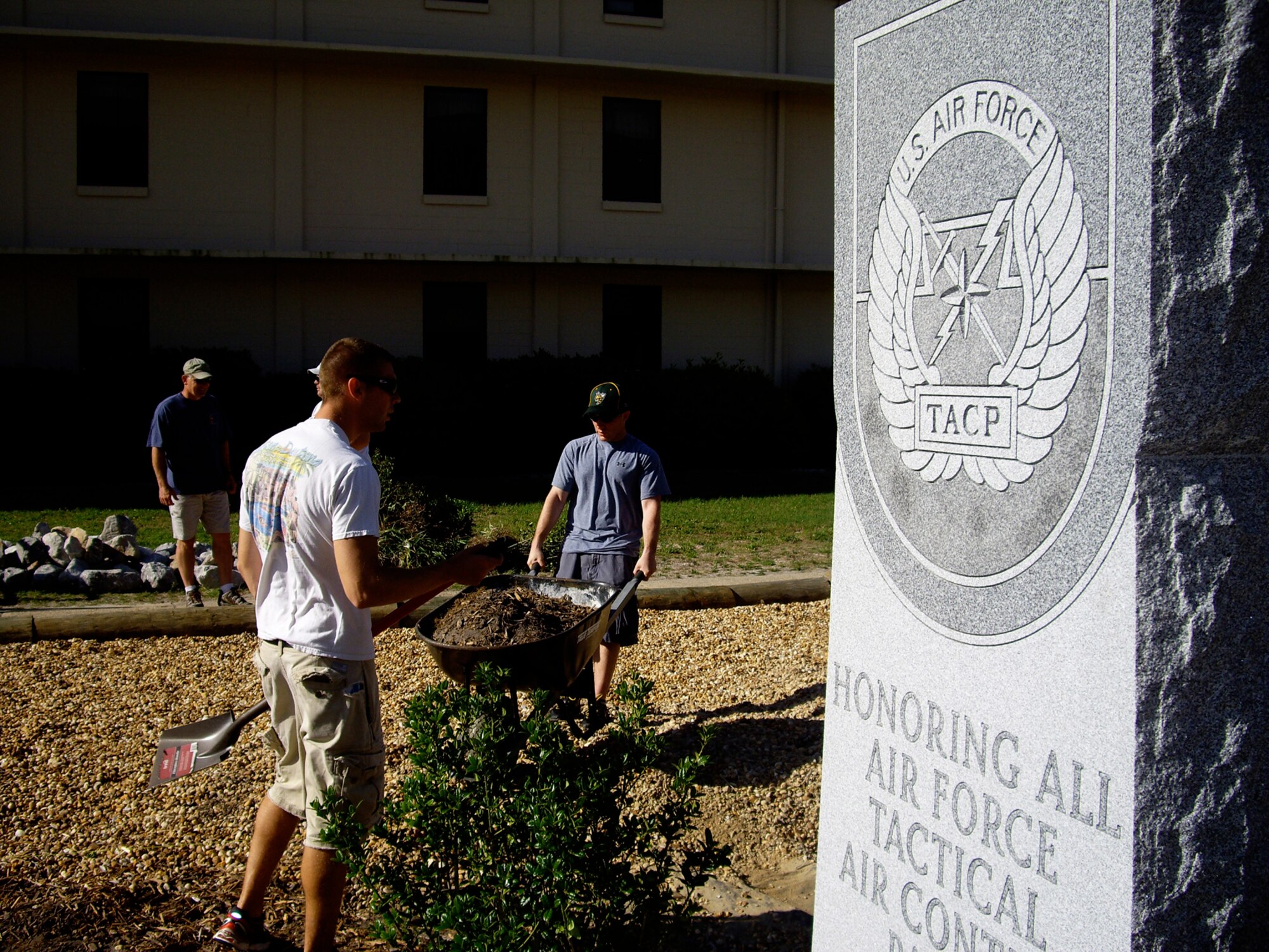 Airmen assigned to the Tactical Air Control Party Schoolhouse clean and landscape the area around the TACP Memorial Wall at Hurlburt Field, Fla., May 16, 2010, in preparation of the upcoming ceremony honoring Senior Airman Bradley Smith. Airman Smith was killed in action in Afghanistan Jan. 3, 2010. He was the third TACP member to be killed since Operation Enduring Freedom began. (Courtesy photo by Tonya Keebaugh)