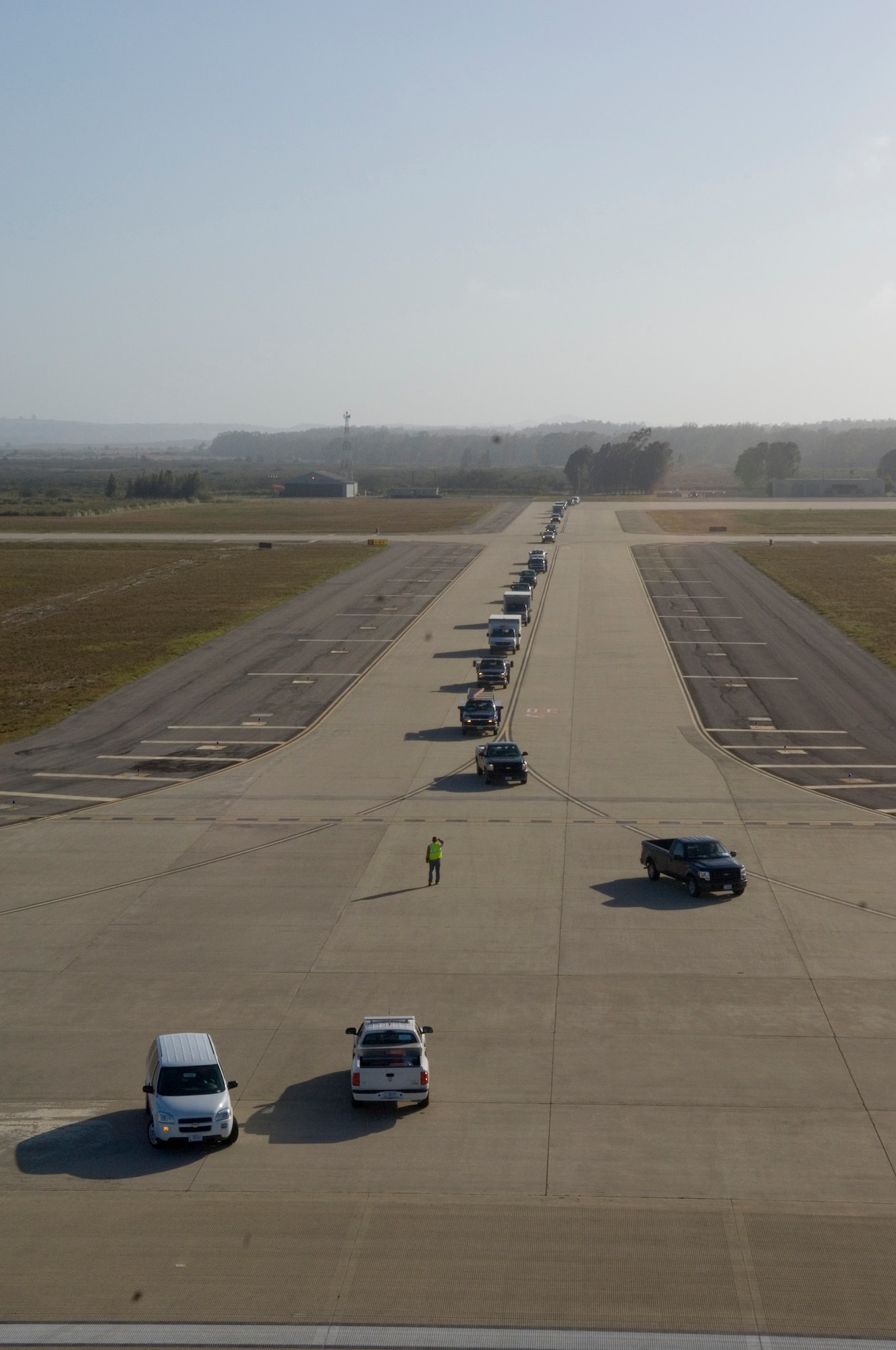 VANDENBERG AIR FORCE BASE, Calif. -- Construction crews drive onto the flight line to prepare it for the X-37B landing here Saturday, May 8, 2010. The crews replaced metal plates in order to make sure the X-37B has a safe landing. (U. S. Air Force photo by Staff Sgt. Levi Riendeau)
