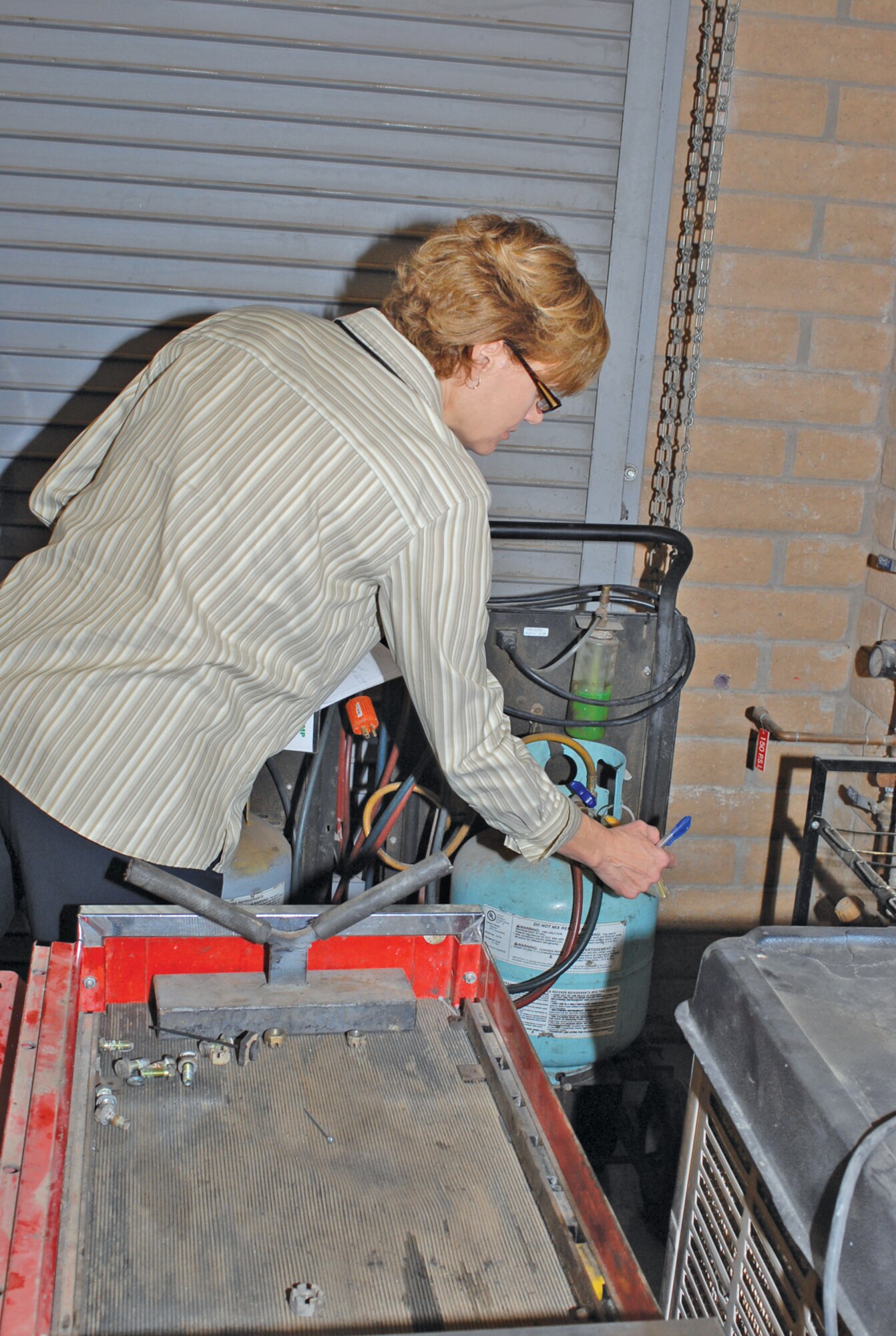 Sally Miller, certified industrial hygienist, conducts an environmental safety and occupational health inspection May 6 in Luke Air Force Base Auto Hobby Shop. The week-long assessment viewed Luke’s mission and daily work routines. The purpose behind the Environmental Safety and Occupational Health Compliance Assessment Management Program inspection is to help manage environmental, safety and occupational health risks while continually improving Luke’s overall performance. (U.S. Air Force photo by Airman 1st Class Sandra Welch)