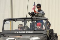Scouts hop into the seat and onto the gun of the Army Jeep on display as part of the flightline activities during the annual Boy Scout Expo held April 30 through May 2 at Beale Air Force Base, Calif. (U.S. Air Force Photo/A1C Adam Hamar) 