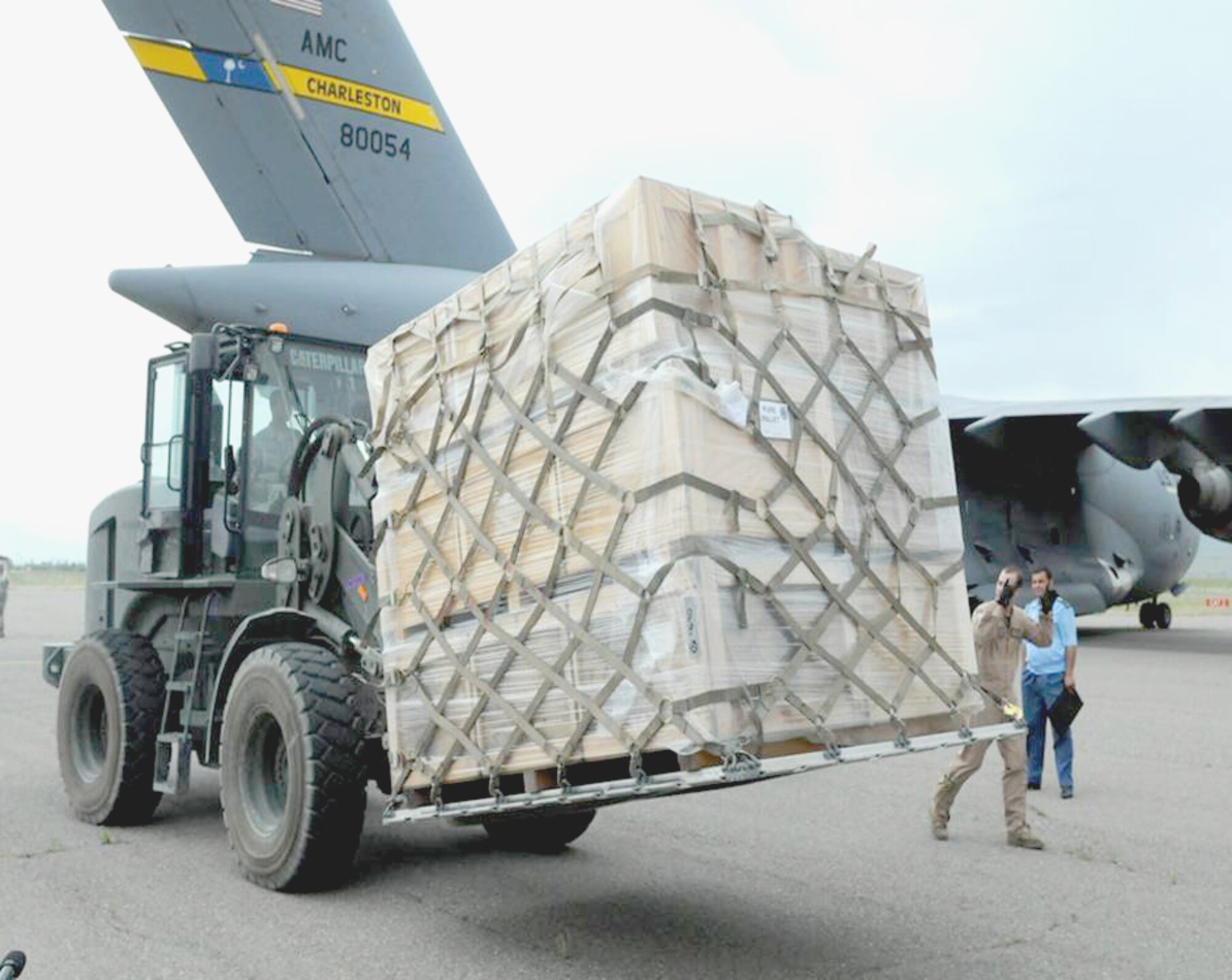 Members of the 817th Expeditionary Airlift Squadron use a forklift to remove a pallet full of tents off of a C-17 Globemaster III to help aid displaced citizens of the recent floods in Tajikistan. (U.S. Army photo/Cpl. Brandon Babbitt)
