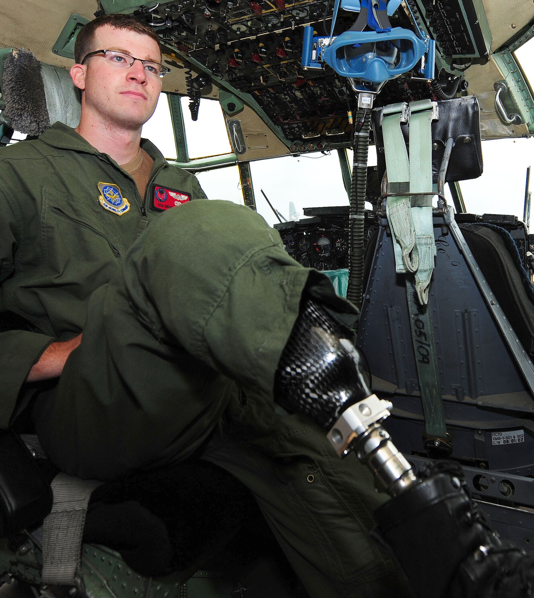 Senior Airman Brian Petras sits in the cockpit of a C-130 Hercules, May 11, 2010, on the flightline at Little Rock Air Force Base, Ark. Airman Petras, diagnosed with cancer in 2009, returned to duty less than a year after a surgery to remove part of his right leg.  He is a flight engineer with the 50th Airlift Squadron.  (U.S. Air Force photo/Senior Airman Steele C. G. Britton)