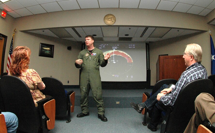 Capt. Christopher Dyke briefs community leaders from the Colorado Springs, Colo., area May 14 on the technical aspects of "hurricane hunting, " or weather reconnaissance at Keesler Air Force Base, Miss. A total of 26 community leaders were escorted to "The Magnolia State" by the 302nd Airlift Wing to learn more about Air Force Reserve special missions, including aerial firefighting and weather reconnaissance. Captain Dyke is a weather reconnaissance officer assigned to the 53rd Weather Reconnaissance Squadron, an Air Force Reserve C-130 Hercules unit. (U.S. Air Force photo/Staff Sgt. Stephen J. Collier)