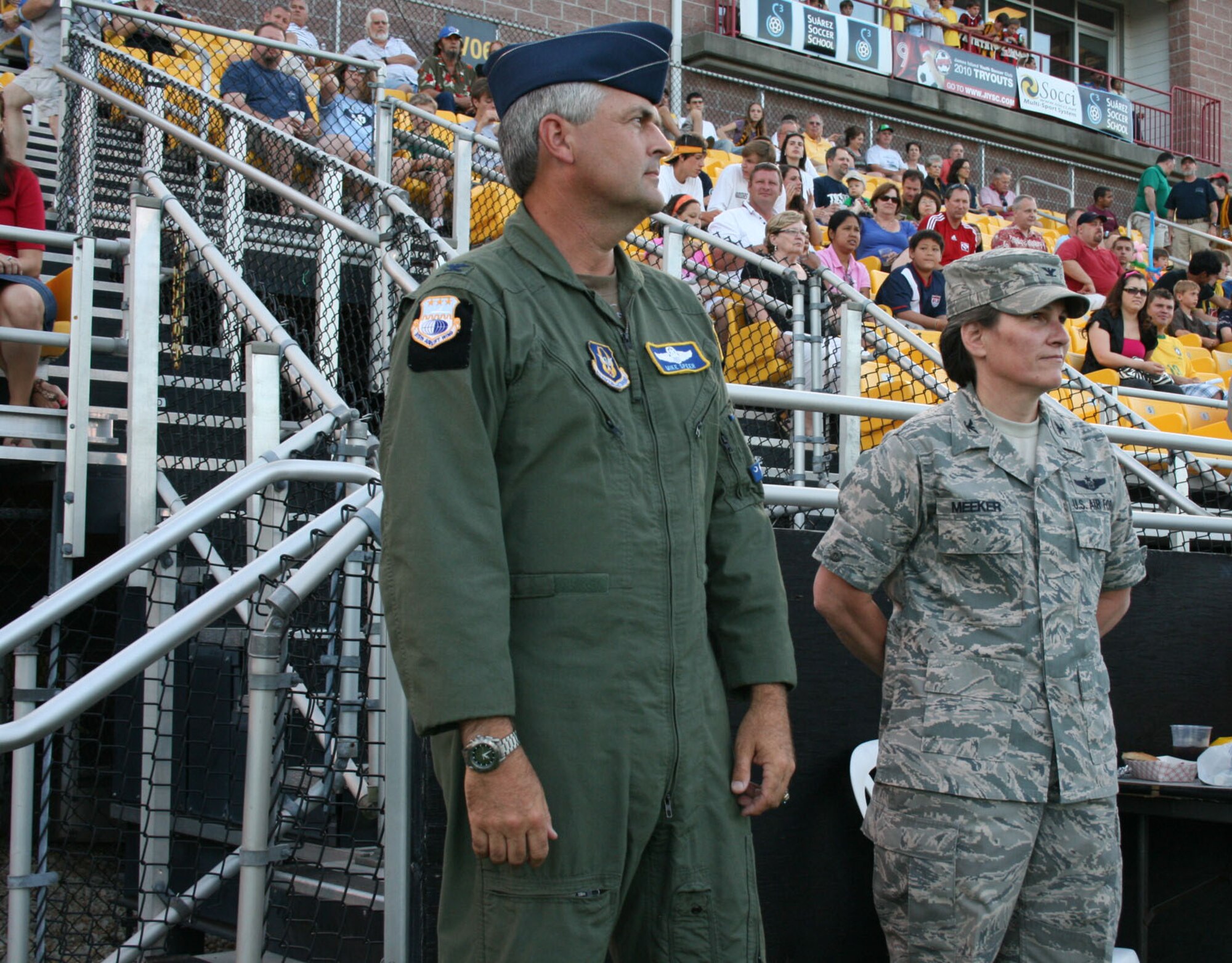 315th Airlift Wing Vice Commander Colonel Mike Speer and 628th Air Base Wing Commander, Charleston Air Force Base S.C., Col. Martha Meeker stand on the sidelines prior to the coin toss at Blackbaud Stadium May 15. Colonels Speer and Meeker were in attendance for miliary appreciation night. (U.S. Air Force Photo/TSgt Jeff Kelly)