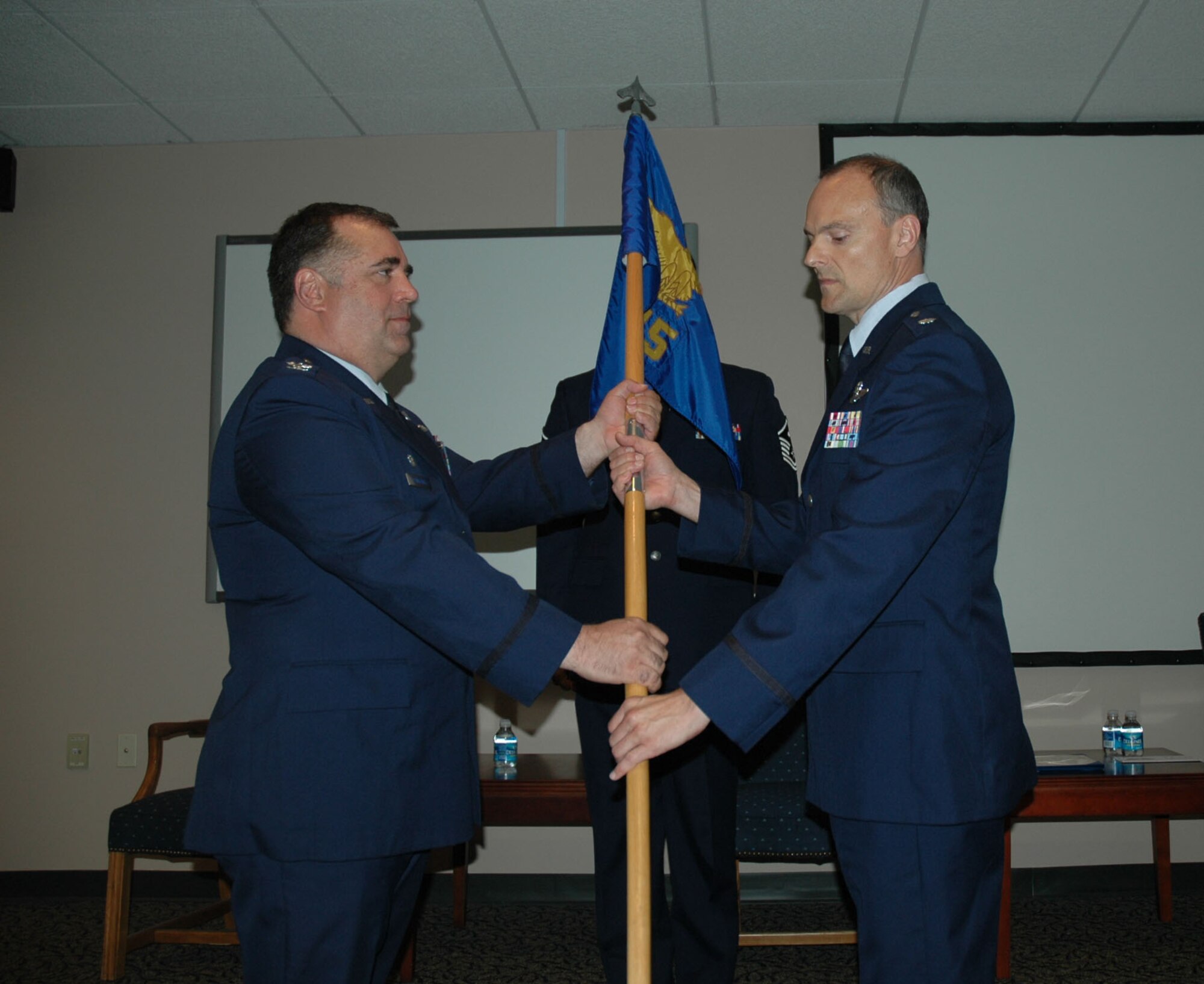 Lieutenant Edward Paylor assumes command of the 317th Airlift Squadron Charleston Air Force Base S.C. May 16 from Colonel Russell Fingar. 315th Operations Group Commander Colonel Terry Lawrence presided over the ceremony. (U.S. Air Force Photo/2nd Lt Joe Simms)
