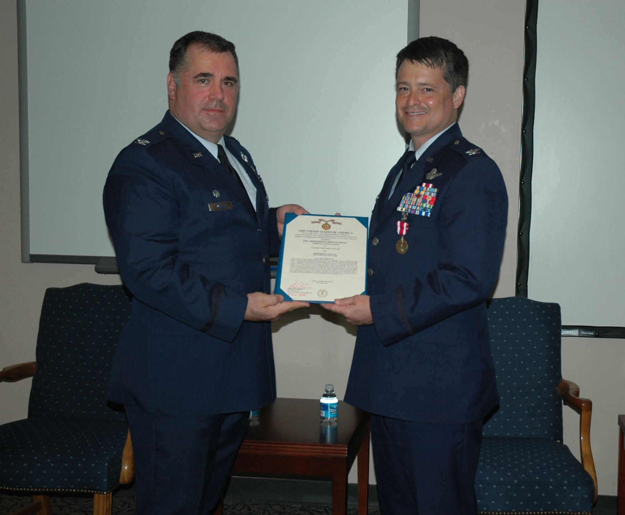 Colonel Terry Lawrence, 315th Airlift Wing Operations Group Commander presented Col. Russell Fingar with the the Meritorious Service Medal during the 317th Airlift Squadron change of command. Col. Fingar assumes the role of 315th vice wing commander June 1. (U.S. Air Force Photo/2nd Lt Joe Simms)