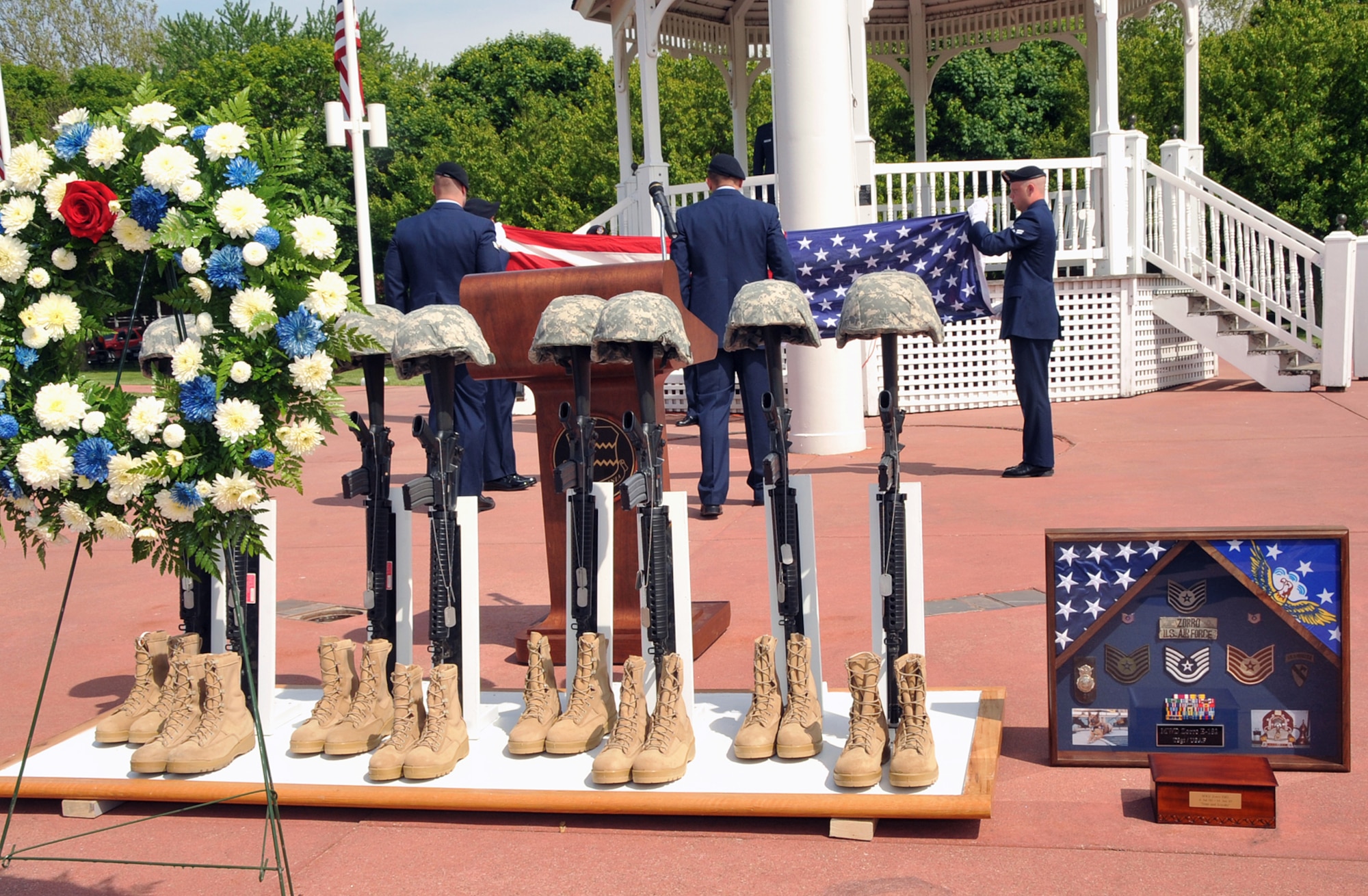 OFFUTT AIR FORCE BASE, Neb. -- Members of the 55th Security Forces Squadron fold the American flag during Offutt's Police Week Retreat Ceremony at the parade grounds here May 14. The event, attended by numerous law enforcement officers from across the Omaha metro area, honored the eight security forces Airmen who died supporting Operation Iraqi Freedom, as well as Zorro, a military working dog who recently passed away. U.S. Air Force Photo by Jeff W. Gates