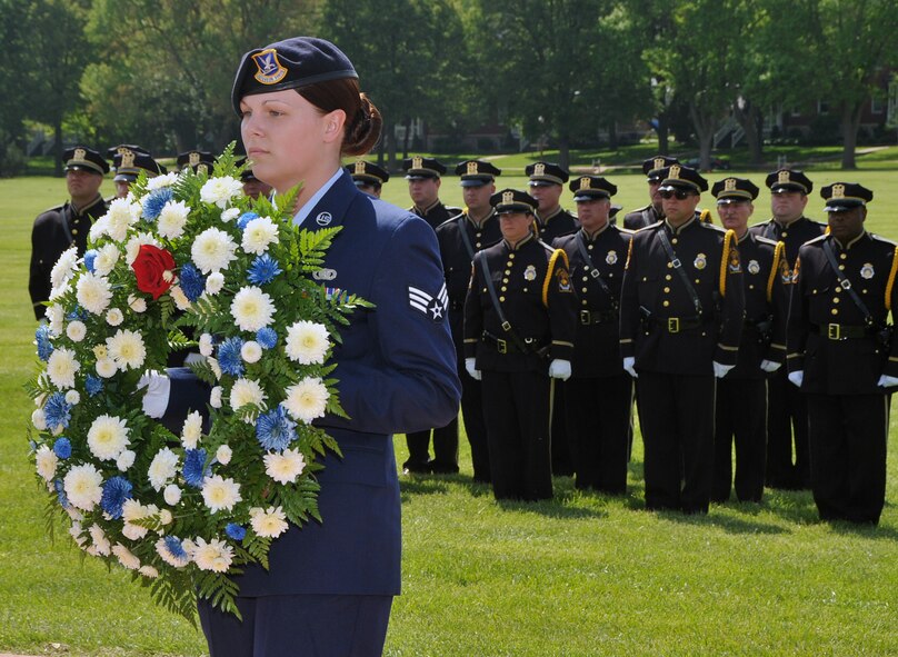 OFFUTT AIR FORCE BASE, Neb. -- Senior Airman Danielle Tibbs, 55th Security Forces Squadron, marches forward to lay a wreath in honor of eight security forces Airmen who died in support of Operation Iraqi Freedom during Offutt's Police Week Retreat Ceremony here May 14. The event, attended by numerous law enforcement officers from across the Omaha metro area, also honored Zorro, a military working dog who recently passed away. U.S. Air Force Photo by Jeff W. Gates.