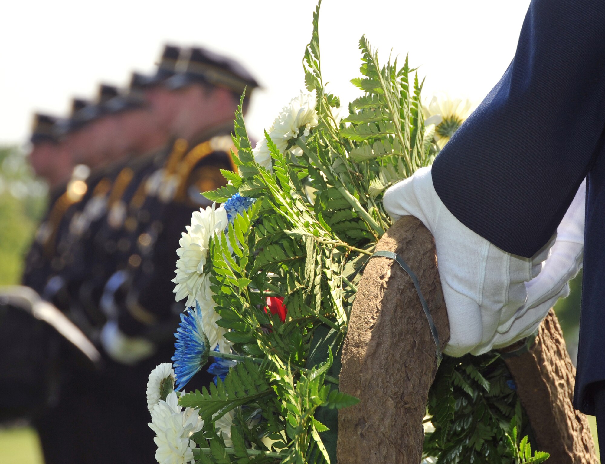 OFFUTT AIR FORCE BASE, Neb. -- Senior Airman Danielle Tibbs, 55th Security Forces Squadron, places a wreat on its stand at the parade grounds here during Offutt's Police Week Retreat Ceremony May 14. The event, attended by numerous law enforcement officers from across the Omaha metro area, honored the eight security forces Airmen who died while supporting Operation Iraqi Freedom as well as Zorro, a military working dog who recently passed away. U.S. Air Force Photo by Jeff W. Gates