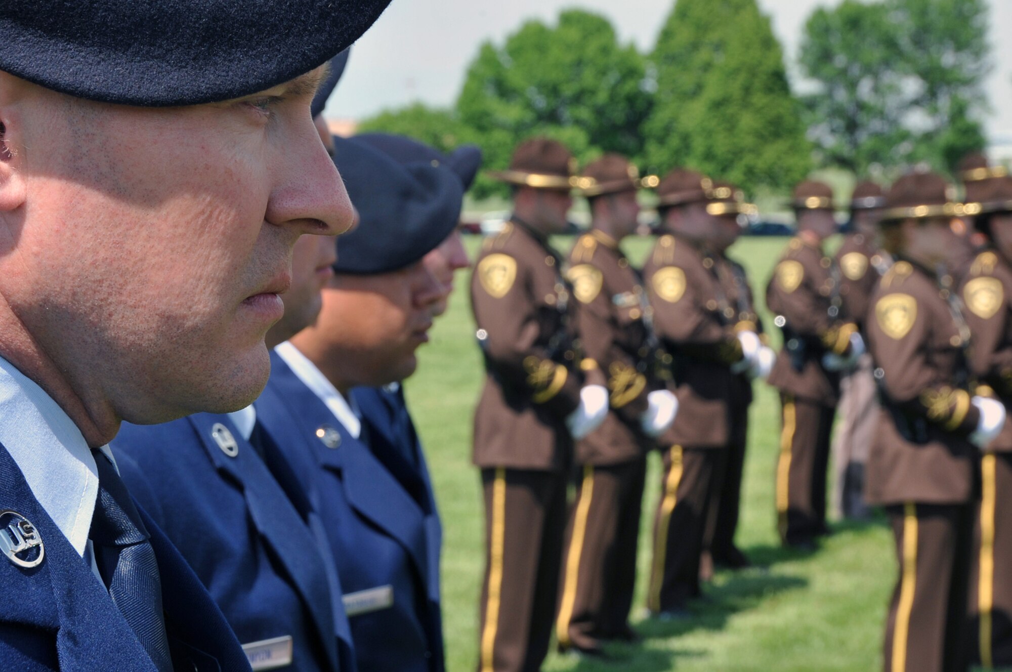 OFFUTT AIR FORCE BASE, Neb. -- Tech. Sgt. Steven Flamming, a flight chief with the 55th Security Forces Squadron, stands at attention with numerous 55th SFS Airmen and several law enforcement officers from across the Omaha metro area during Offutt's Police Week Retreat Ceremony at the parade grounds here May 14. The event, honored the eight security forces Airmen who died while supporting Operation Iraqi Freedom, as well as Zorro, a military working dog who recently passed away. U.S. Air Force Photo by Jeff W. Gates
