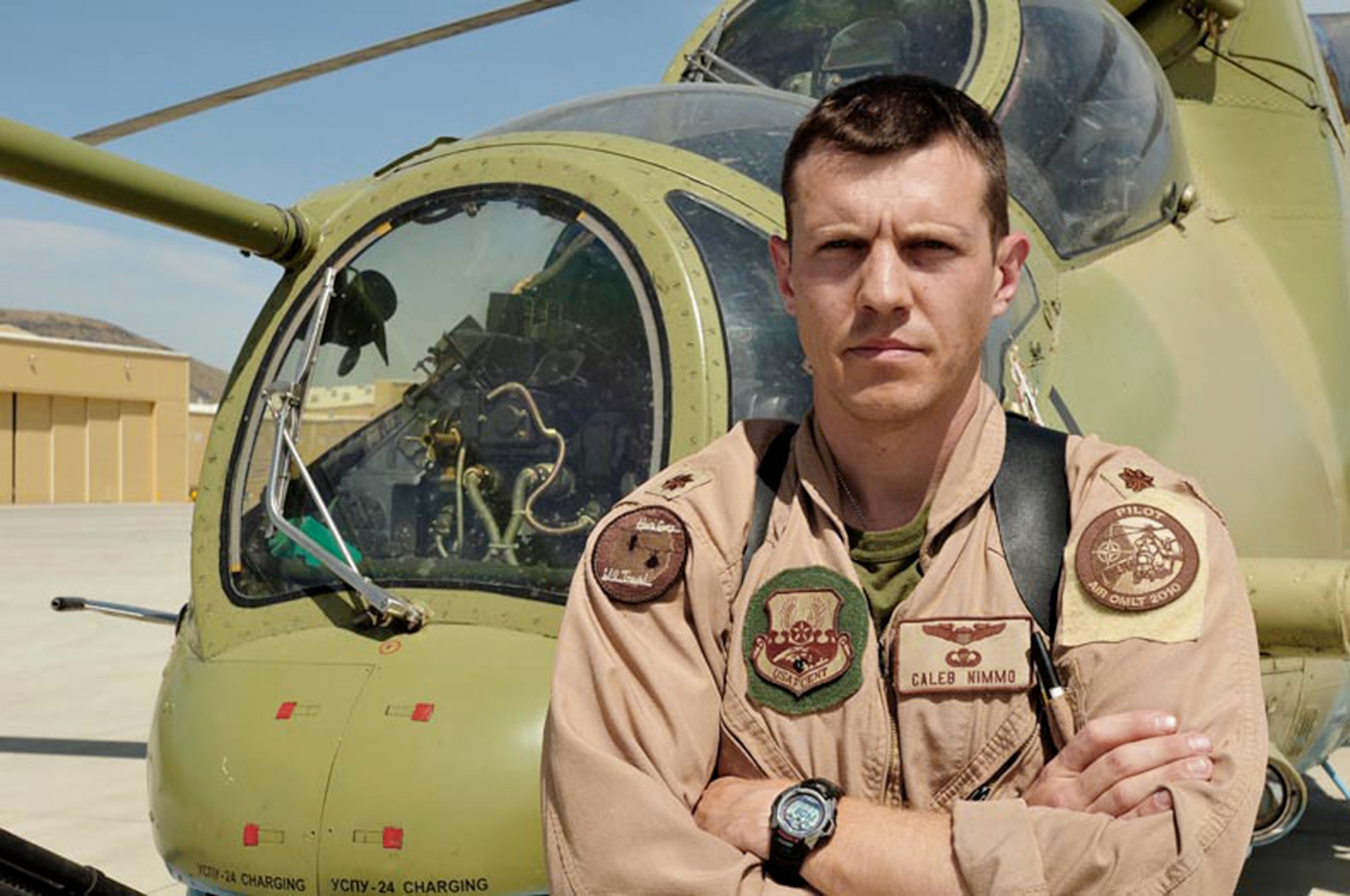 Maj. Caleb Nimmo poses next to a Russian-made Mi-35 attack helicopter May 15, 2010, at the Afghan National Army Air Corps base in Kabul, Afghanistan.  Major Nimmo is with the 438th Air Expeditionary Wing Combined Air Power Transition Force.  (U.S. Navy photo/Petty Officer 1st Class Elizabeth Burke)