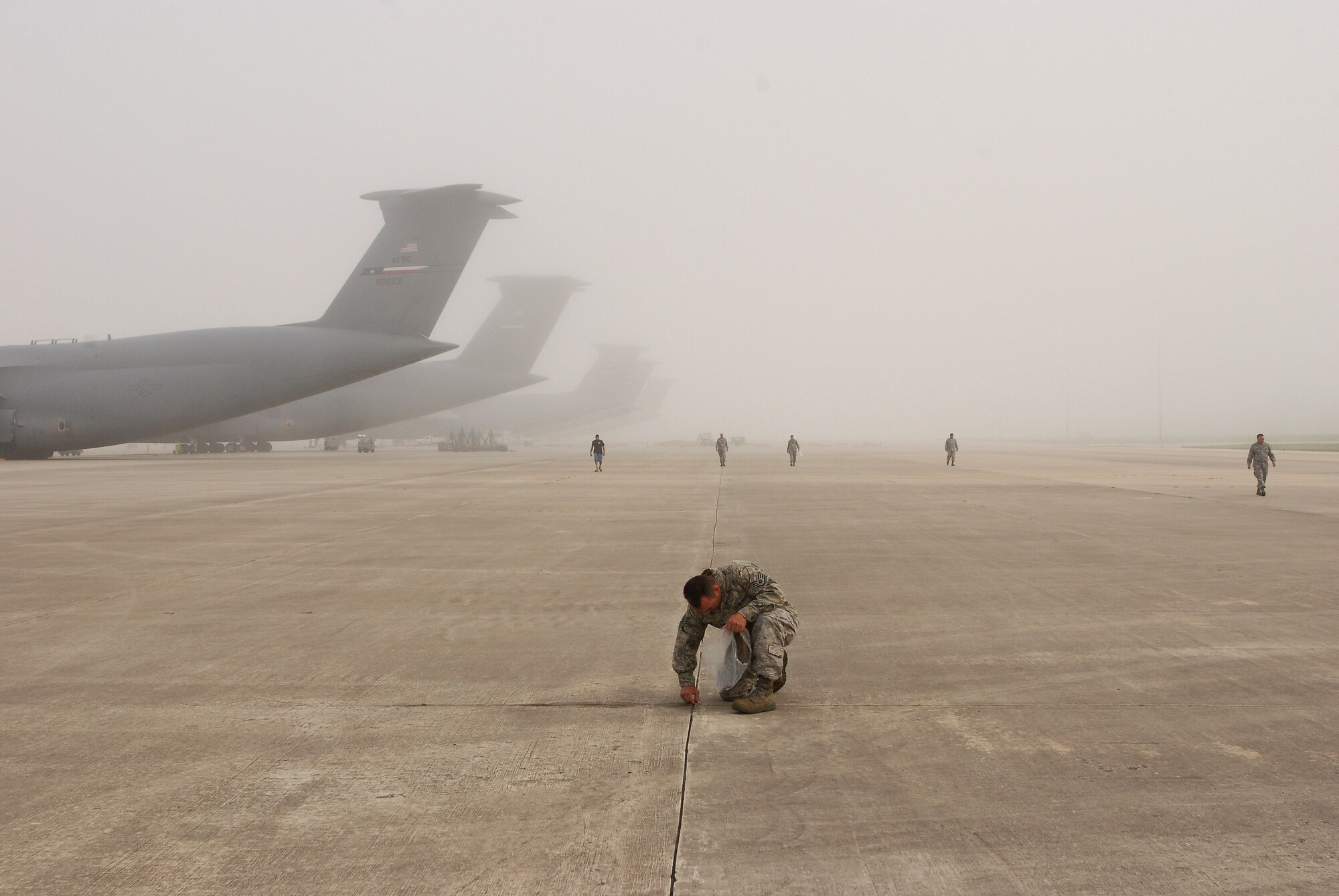 Staff Sgt. John Petrie, 433rd Maintenance Operation Squadron, Lackland Air Force Base, Texas, stops to pick up a piece of debris from the flightline.

Members of the Alamo Wing walk the flightline in a Monday morning ritual searching for foreign object debris. 

Everyone from Col. Kenneth Lewis, wing commander,  to the brand new airman basics participate. The FOD is collected in a bag and properly disposed of. The wing vice commander Col. Dale Andrews, hides a gold-painted bolt somewhere to be found as incentive to be thorough during the FOD walk. Whomever finds the golden bolt wins their 15 minutes of fame and thanks from the roaring jet engines. (U.S. Air Force photo Airman 1st Class Brian McGloin)