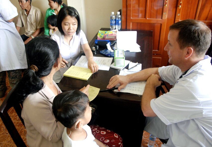 Lt. Col. Gerald Delk (right) and Nha Nguyen ask two Vietnamese patients medical-related questions during a visit to the family practice clinic May 14, 2010, in Truong Thanh, Vietnam. More than 50 U.S. servicemembers are in Vietnam working alongside the Vietnamese military, non-governmental organizations and civil health and engineering members in humanitarian medical and engineering efforts. Colonel Delk is from the 920th Aeromedical Staging Squadron at Patrick Air Force Base, Fla. (U.S. Air Force photo/Capt. Timothy Lundberg)
