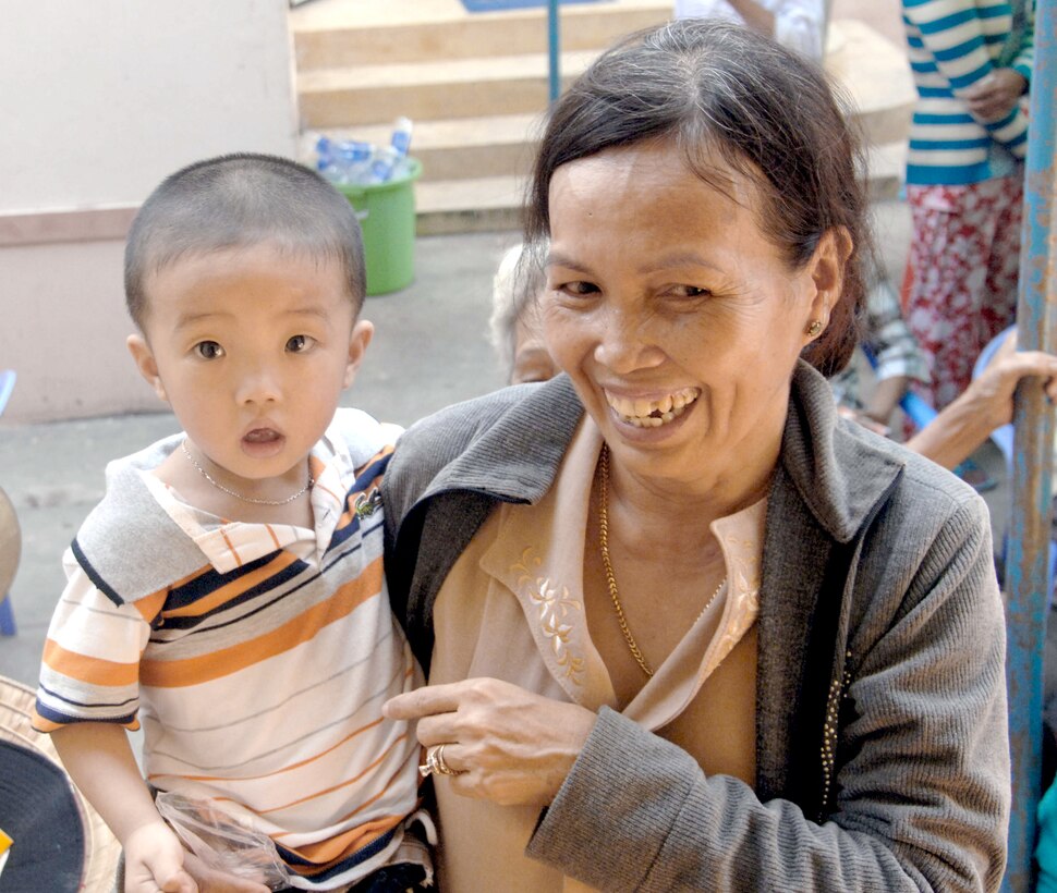 A Vietnamese mother and child wait to receive prescription medicine from the Truong Thanh medical clinic May 14, 2010, as part of Operation Pacific Angel 2010. Operation Pacific Angel is a joint and combined humanitarian assistance operation conducted in the Pacific area of responsibility to support the members of the U.S. Pacific Command's capacity-building efforts. (U.S. Air Force photo/Capt. Timothy Lundberg)