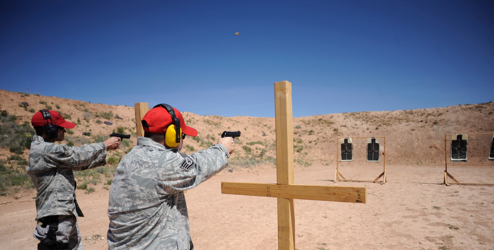27th Special Operations Security Forces Squadron Airmen shoot at targets May 13 at Patriot Outdoors.  The pistol shooting competition was a part of the National Police Week events that took place May 9-15. (U.S. Air Force Photo by Senior Airman Evelyn Chavez)