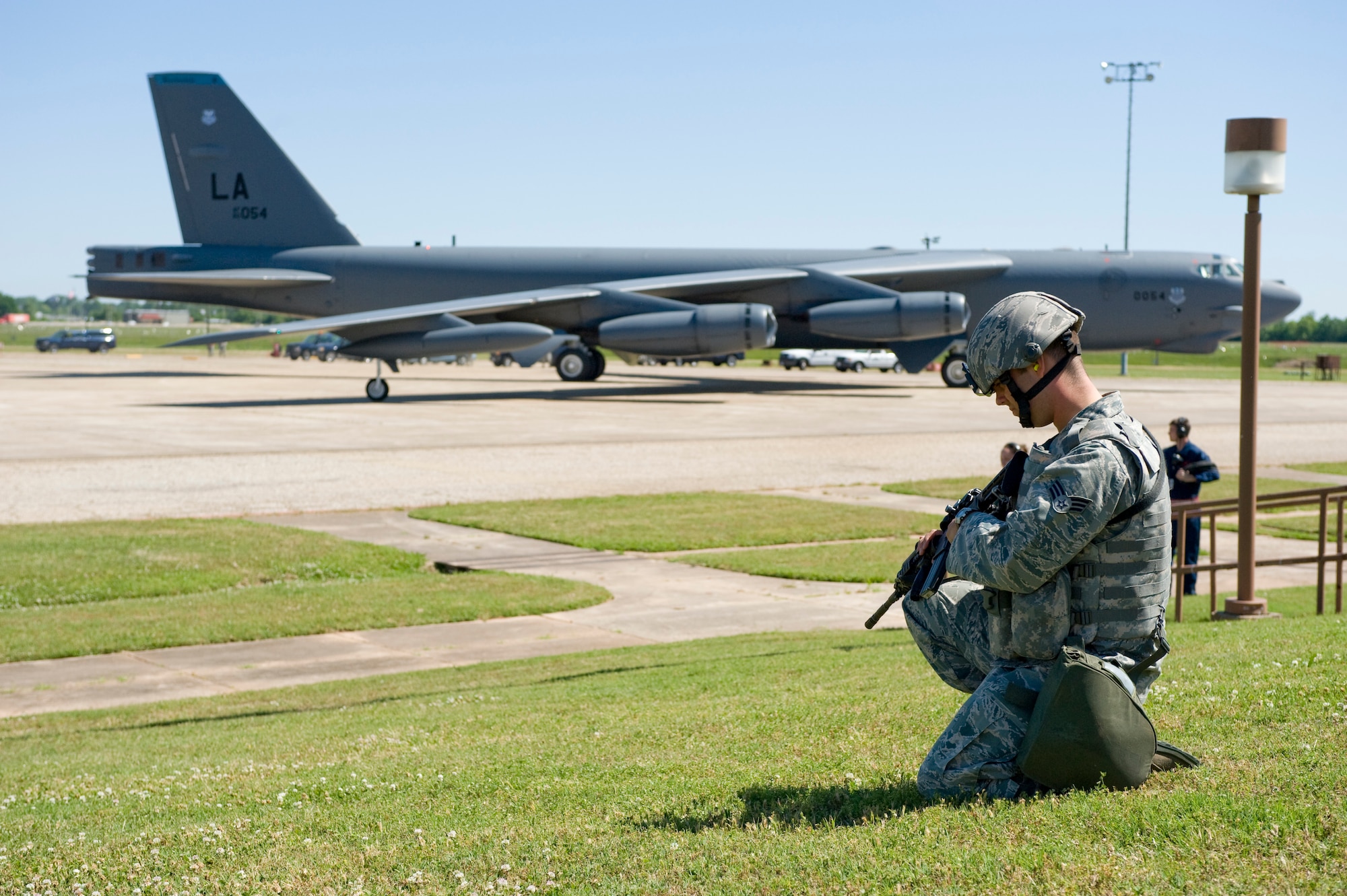 BARKSDALE AIR FORCE BASE, La. – A patrolman from the 2d Security Forces Squadron keeps watch as a B-52 Stratofortress taxis to the runway during a Nuclear Operational Readiness Exercise May 8. The NORE was held to test the weapons-response capability of Barksdale Airmen. (U.S. Air Force photo / Senior Airman Chad Warren)