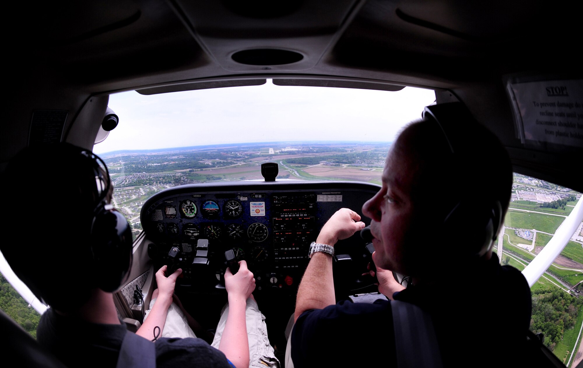 OFFUTT AIR FORCE BASE, Neb. -- Fourteen-year-old Nolan Raper, a Bellevue resident, and Dan Reyome, a flight instructor here, approach Offutt's runway to do a series of landings and take offs during Aviation Opportunities Day hosted by the LeMay Aero Club here May 15. Those who attended the event were given hands on training on how to prep an aircraft for preflight and instrument instructions. Attendees also toured aircraft and took a one hour introductory flight with an instructor. U.S. Air Force Photo by Josh Plueger 
