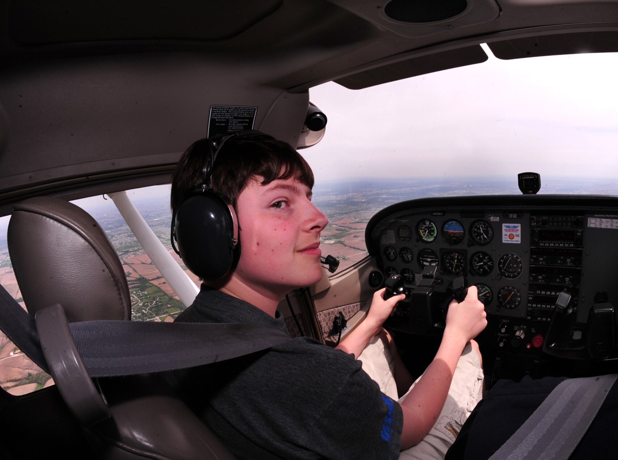 OFFUTT AIR FORCE BASE, Neb. -- Fourteen-year-old Nolan Raper, a Bellevue resident, under the watchful eye of Dan Reyome, a flight instructor here, approaches the Offutt runway to do a series of landings and take offs during Aviation Opportunities Day hosted by the LeMay Aero Club here May 15.  Those who attended the event were given hands on training on how to prep an aircraft for preflight and instrument instructions. Attendees also were given aircraft tours and a one hour introductory flight with an instructor. U.S. Air Force Photo by Josh Plueger 
