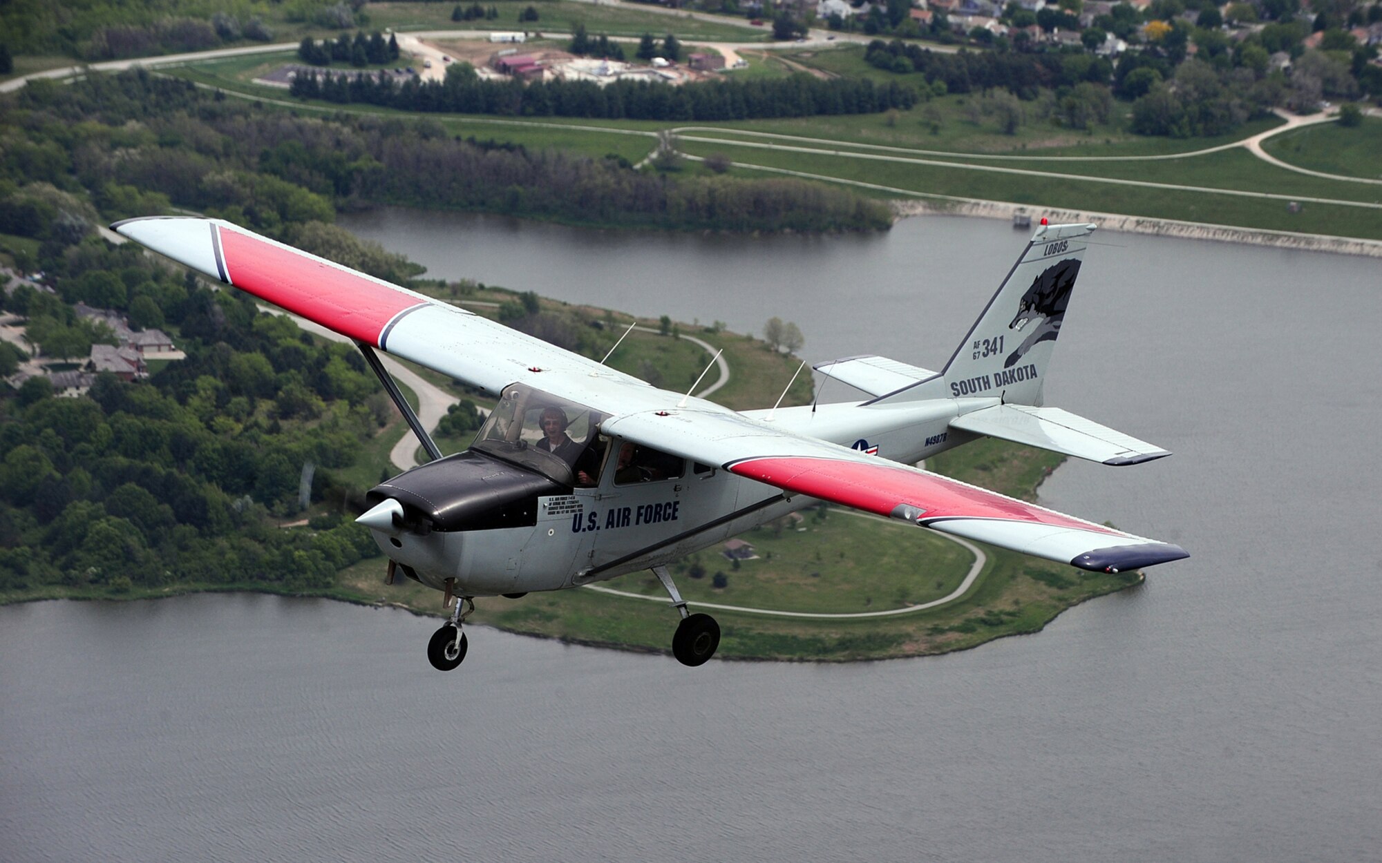 OFFUTT AIR FORCE BASE, Neb. -- Flight Instructor Barb Kalden flies over Zorinsky Lake during Aviation Opportunities Day here hosted by the LeMay Aero Club May 15. The event, provided teenagers with hands on training on how to prep an aircraft for preflight and instrument instructions. Attendees were also given aircraft tours and a one hour introductory flight with an instructor. U.S. Air Force Photo by Josh Plueger 
