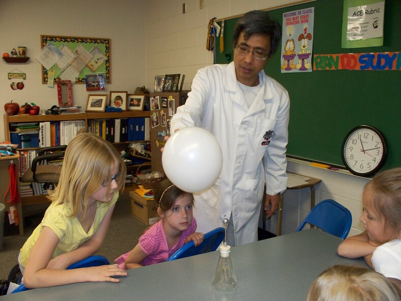 HOLLOMAN AIR FORCE BASE, N.M. -- Dr. Ken Cheung, the director and owner of the Mad Science Company in El Paso, Texas, performs a science experiment with Team Holloman children during a Mad Science Workshop at the Holloman Middle School April 5, 2010. The Airman and Family Readiness Center hosted the event as a part of the Year of the Air Force Family. During the workshop for the children, the A&FRC held briefings to the parents in attendance, especially for those who have a deployed spouse, informing them of the numerous resources available to them. (Courtesy photo / Released)