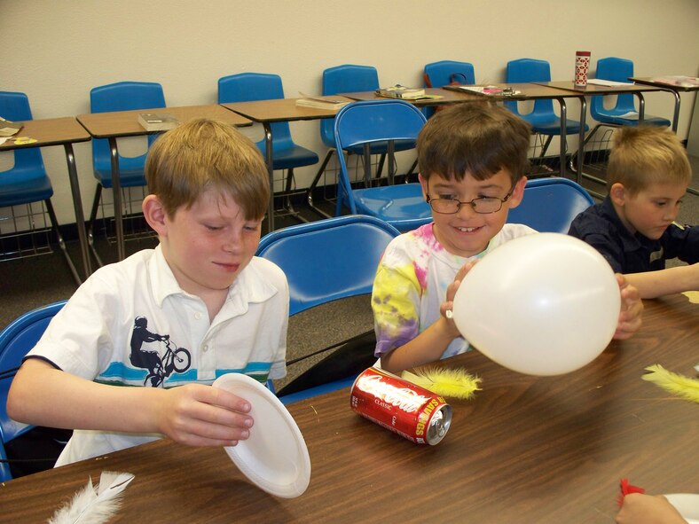 HOLLOMAN AIR FORCE BASE, N.M. -- Team Holloman children perform a science experiment during a Mad Science Workshop at the Holloman Middle School April 5, 2010. The Airman and Family Readiness Center hosted the workshop for military kids from kindergarten to eighth grade. More than 40 children turned out for the workshop and more than 100 parents, family members and friends were in attendance for the assembly performed by the children afterward.(Courtesy photo / Released) 