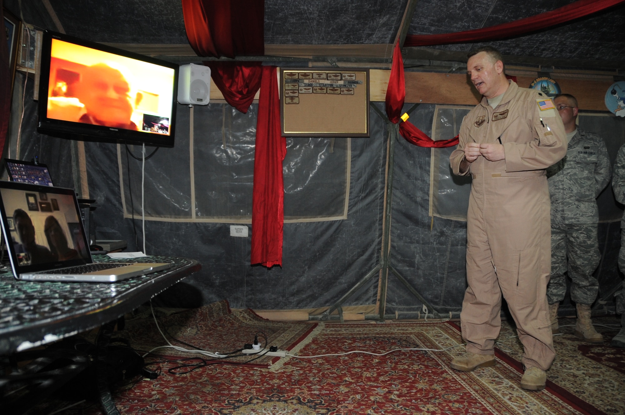 Lt. Col. Daryl Page, 380th Expeditionary Operations Support Squadron commander, talks via video teleconference with retired Lt. Col. Robert Weaver, a former B-24 Liberator pilot during World War II with the 380th Bombardment Group, during a special presentation by Colonel Page and other 380th AEW members honoring 380th BMG veterans May 12, 2010, at a non-disclosed base in Southwest Asia. (U.S. Air Force Photo/Senior Airman Jenifer H. Calhoun/Released)