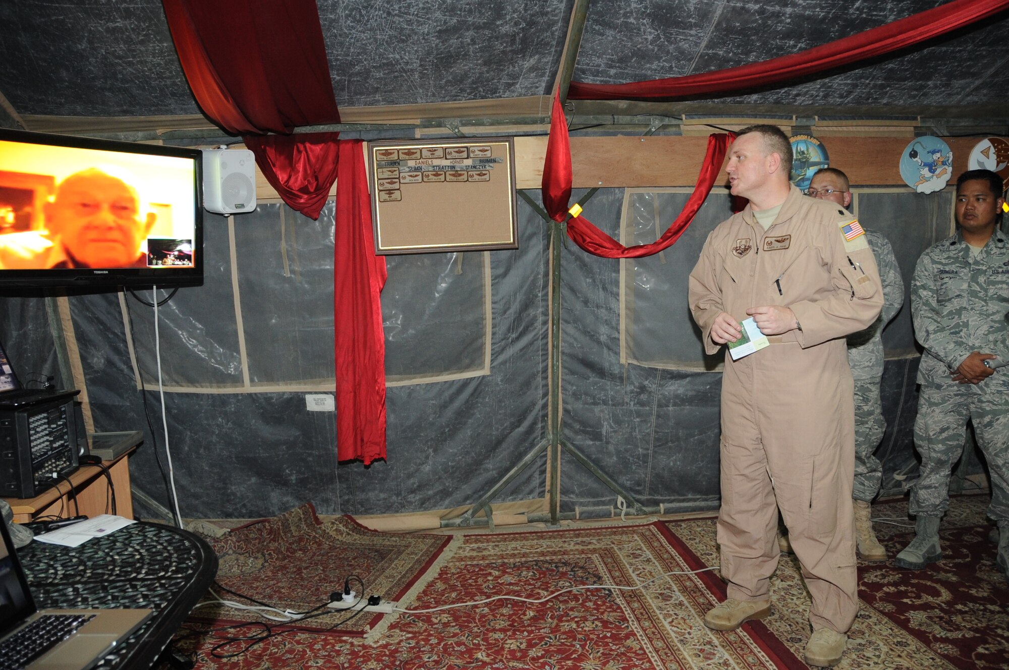 Lt. Col. Daryl Page, 380th Expeditionary Operations Support Squadron commander, talks via video teleconference with retired Lt. Col. Robert Weaver, a former B-24 Liberator pilot during World War II with the 380th Bombardment Group, during a special presentation by Colonel Page and other 380th AEW members honoring 380th BMG veterans May 12, 2010, at a non-disclosed base in Southwest Asia. (U.S. Air Force Photo/Senior Airman Jenifer H. Calhoun/Released)