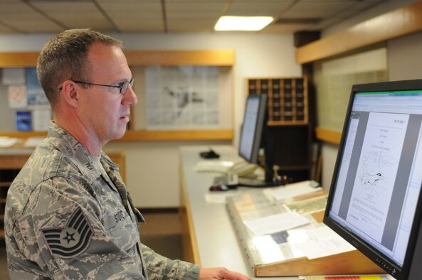 Tech. Sgt. Todd Stuve maintains publications and F-16 operating procedures at the 162nd Fighter Wing, part of his duties in the unit’s standardization and evaluation office. (Air Force photo by Maj. Gabe Johnson)
