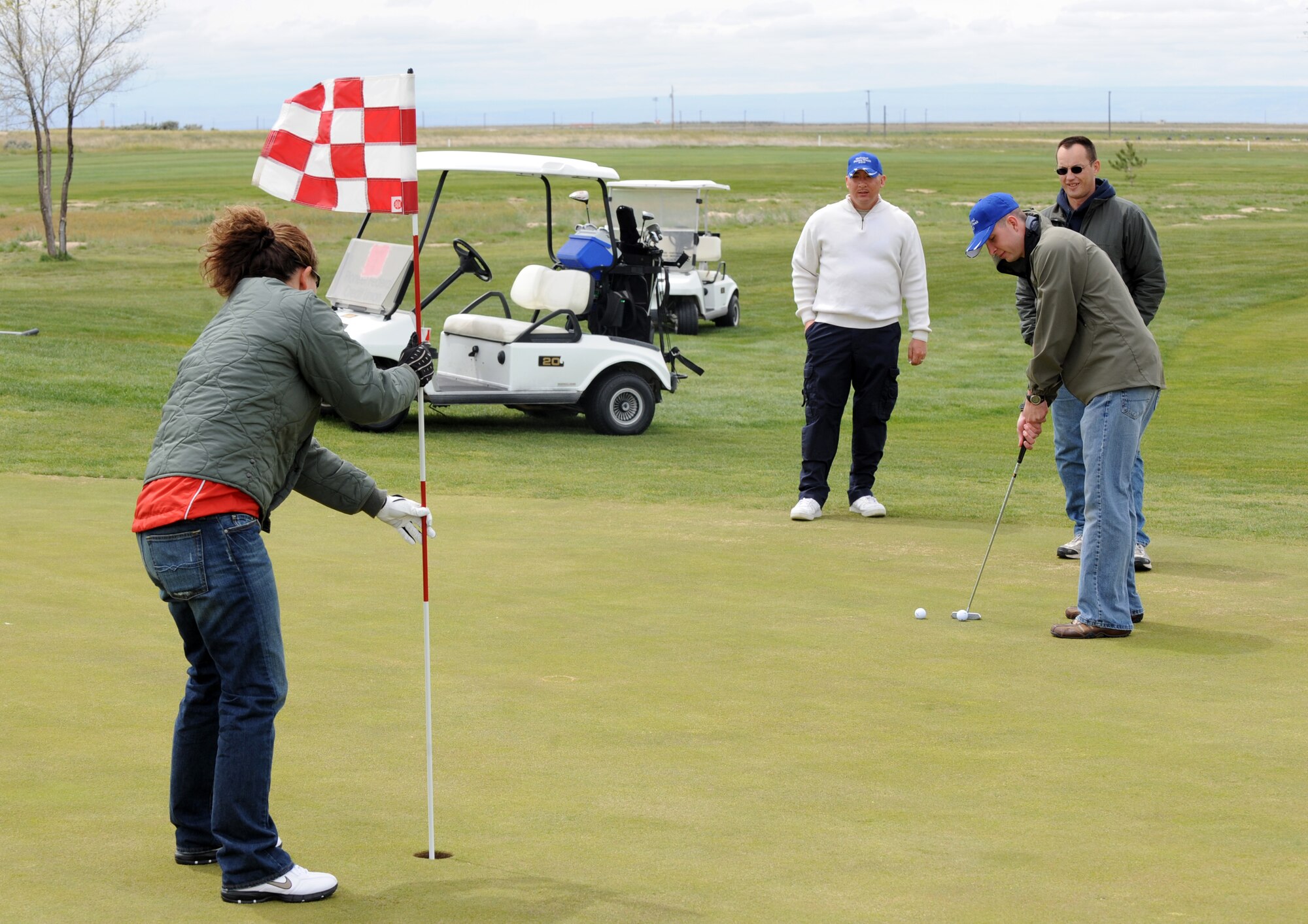 MOUNTAIN HOME AIR FORCE BASE, Idaho -- A team from the Security Forces Squadron, finishes a hole during a golf tournament celebrating National Police Week May 10. National Police week is a time to pay tribute to law enforcement officers who lost their lives in the line of duty for the safety and protection of others, according to the National Peace Officer's Memorial Fund website. (U.S. Air Force photo by Airman 1stClass Debbie Lockhart)