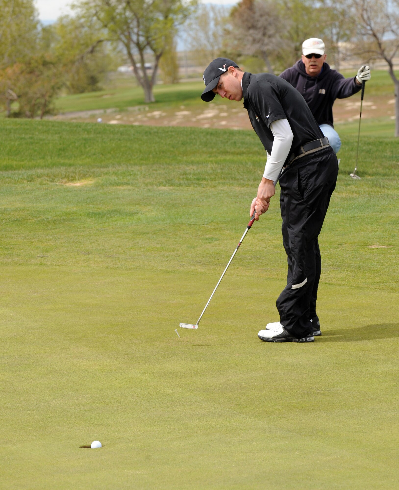 MOUNTAIN HOME AIR FORCE BASE, Idaho -- Airman 1st Class Joseph Hunt, 366th Security Forces Squadron patrolman, makes par during a golf tournament celebrating National Police Week May 10. National Police week is a time to pay tribute to law enforcement officers who lost their lives in the line of duty for the safety and protection of others, according to the National Peace Officer's Memorial Fund website. (U.S. Air Force photo by Airman 1stClass Debbie Lockhart)