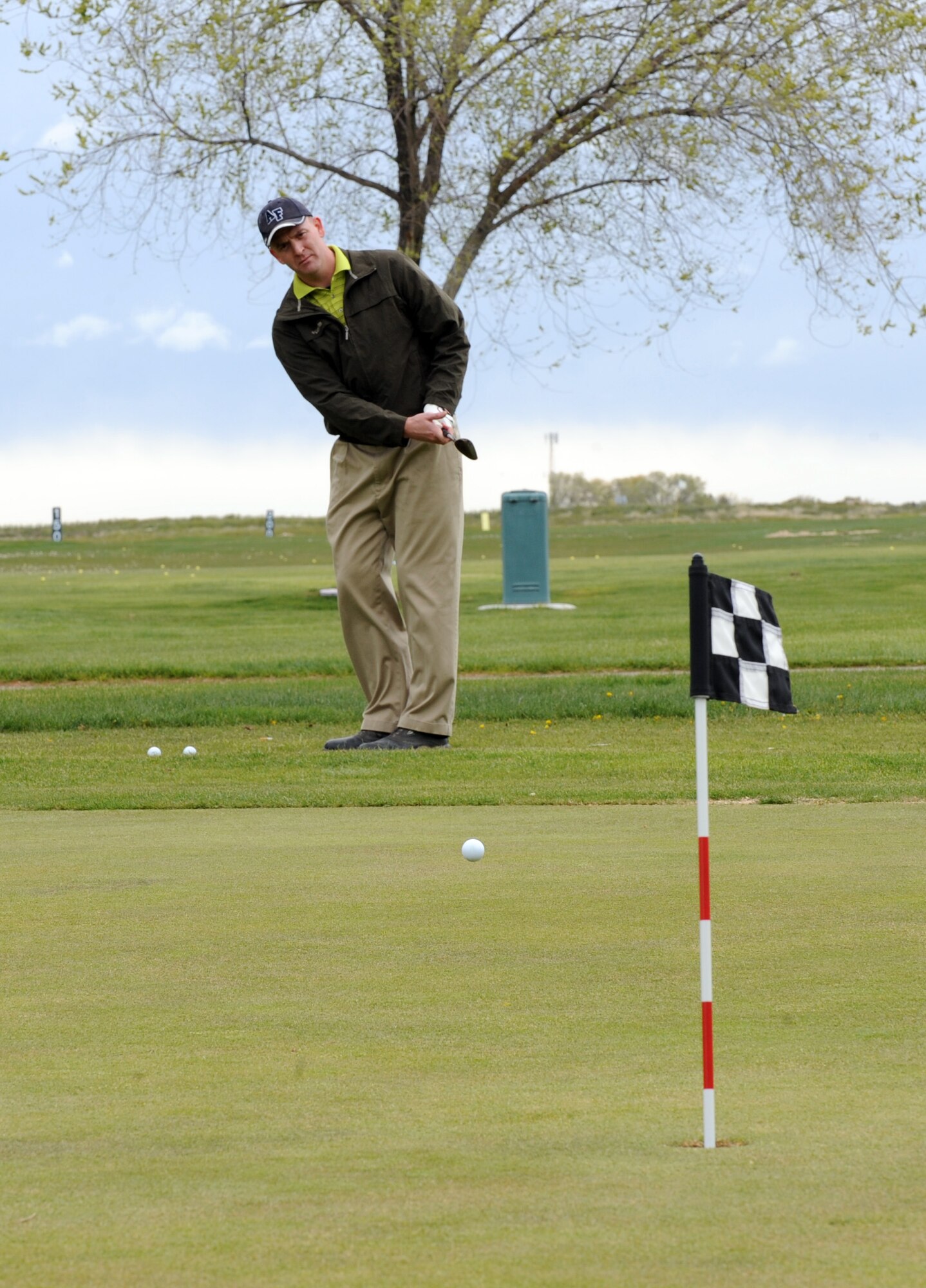 MOUNTAIN HOME AIR FORCE BASE, Idaho -- Master Sgt. Phillip Peters, 366th Fighter Wing Staff first sergeant, practices chipping before a golf tournament celebrating National Police Week May 10. National Police week is a time to pay tribute to law enforcement officers who lost their lives in the line of duty for the safety and protection of others, according to the National Peace Officer's Memorial Fund website. (U.S. Air Force photo by Airman 1stClass Debbie Lockhart)