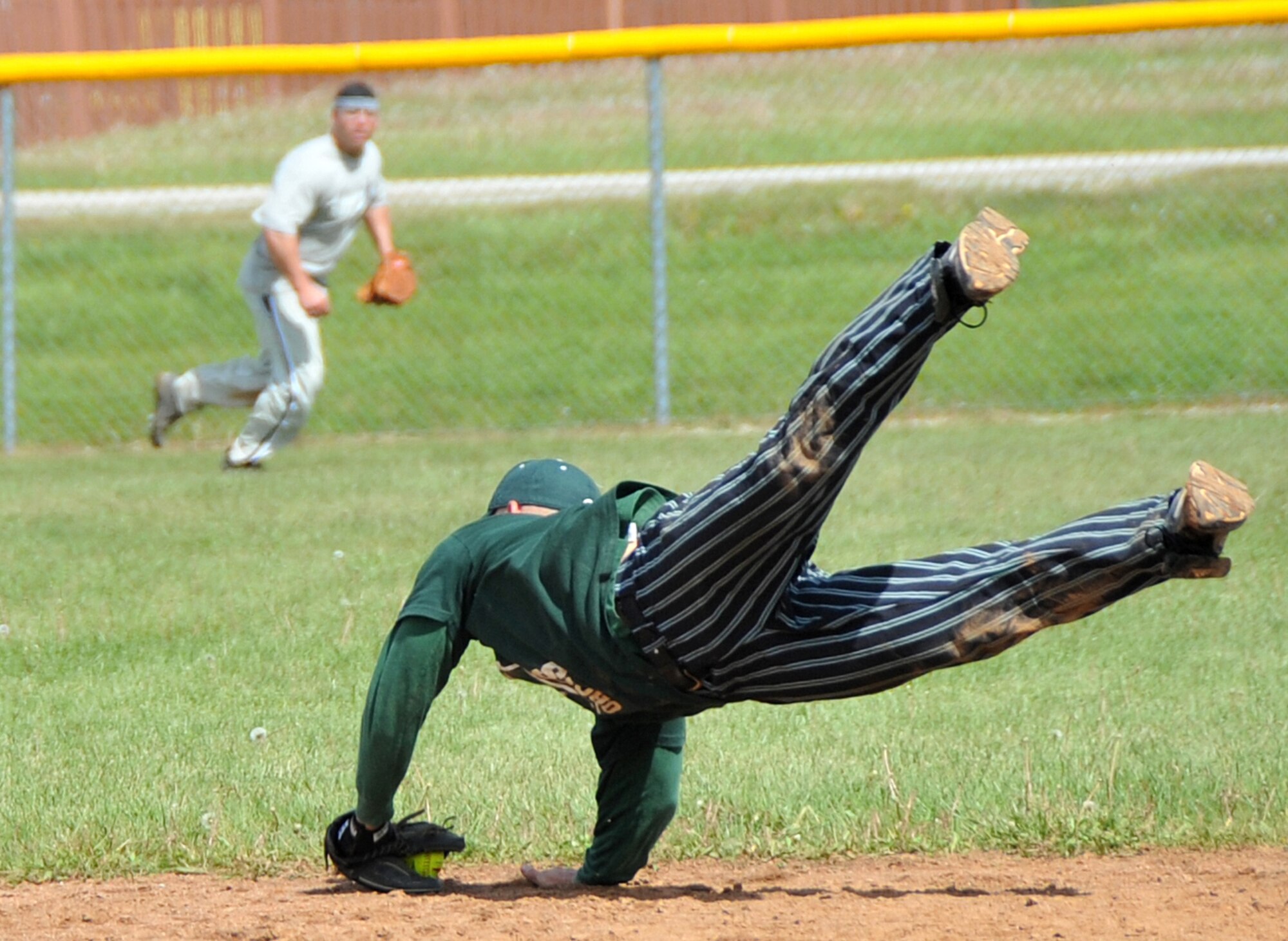 OFFUTT AIR FORCE BASE, Neb. -- Tech. Sgt. Nicholas Melenka, 55th Security Forces Squadron, dives to catch a line drive during Offutt's Police Week Softball Tournament here May 13. The tournament was one of Offutt's many events in observance of National Police Week which also included a static weapons display, military working dog demonstration and a retreat ceremony. U.S. Air Force Photo by Jeff W. Gates.
