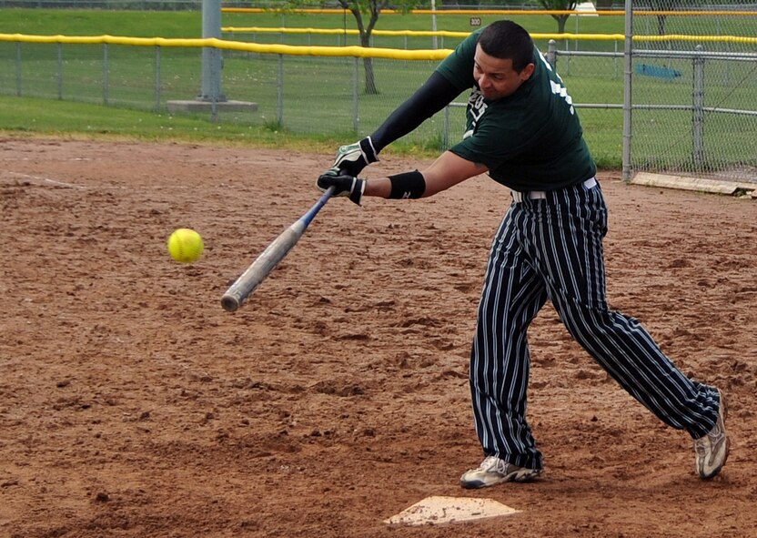 OFFUTT AIR FORCE BASE, Neb. -- Senior Airman Kevin Carlo, 55th Security Forces Squadron, tries to get a piece of the ball during Offutt's Police Week Softball Tournament here May 13. The tournament was one of Offutt's many events in observance of National Police Week which also included a static weapons display, military working dog demonstration and a retreat ceremony. U.S. Air Force Photo by Jeff W. Gates.