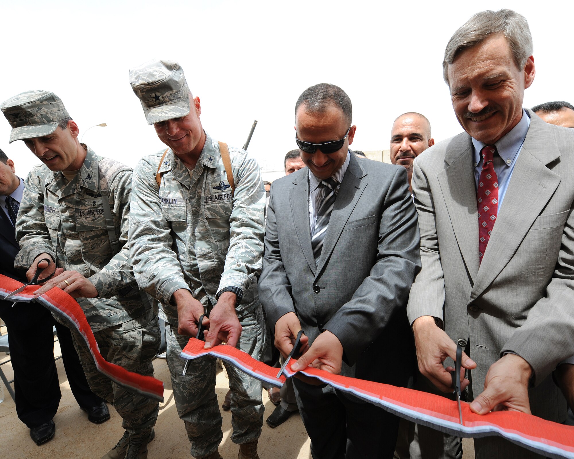 Col. Mark Koeniger, 332nd Expeditionary Medical Group commander; Brig. Gen. Craig Franklin, 332nd Air Expeditionary Wing commander; Mr. Ahmed Al-Krayen, acting Governor of Sala Al Din; and Mr. David Stewart, Provincial Reconstruction Team leader, cut the ribbon at the opening of the U.S.-Iraqi Medical Training Facility at Joint Base Balad, Iraq, May 15, 2010. The facility will provide a safe environment for U.S. medics to conduct civil military engagements with Iraqi healthcare professionals. The goal is to mentor Iraqi healthcare professionals on the team concept of patient assessment and care. (U.S. Air Force photo/Master Sgt. Linda C. Miller/Released)
