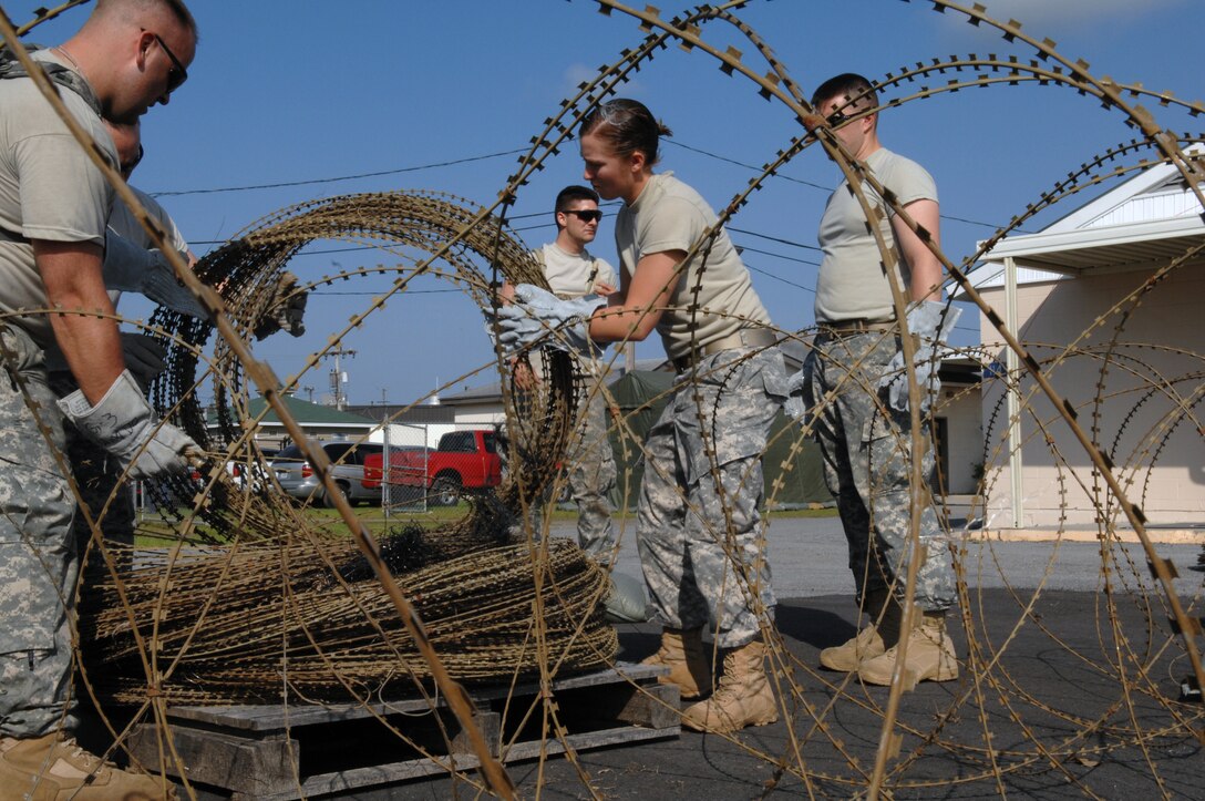 Savannah GA. -- U.S. Army Soldiers set up a perimeter with C- wire during Ardent Sentry 2010 on the Savannah Combat Readiness Training Center in Savannah, GA. (U.S. Air Force photo by AMN Allen Stokes)